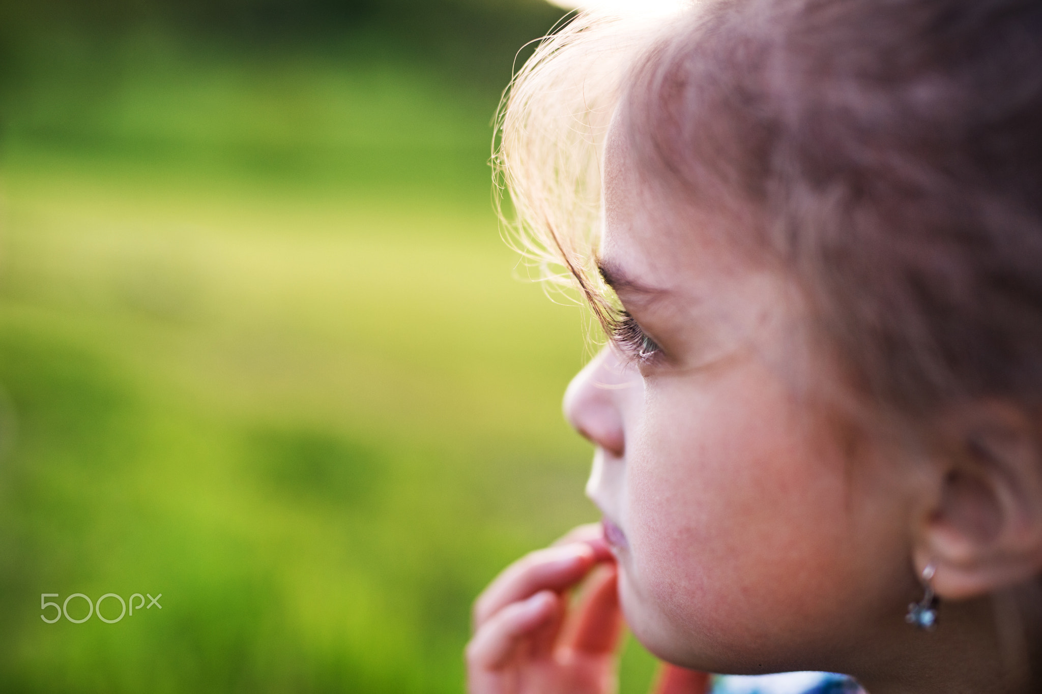 A small girl in the garden in spring nature. Copy space.