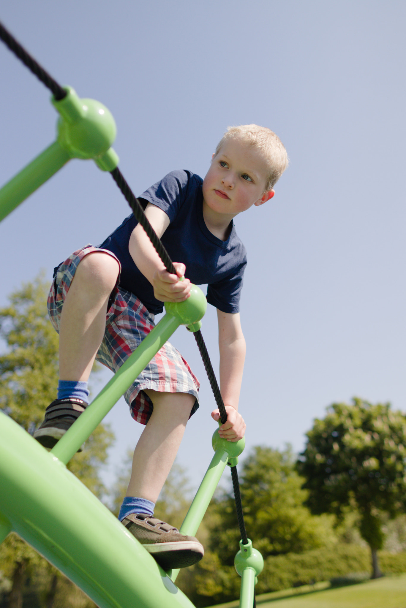 Canon EOS 80D + Canon EF 24mm F1.4L II USM sample photo. Boy on green climbing frame photography