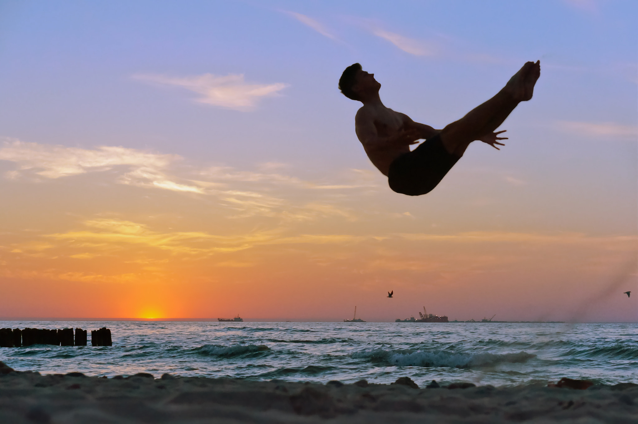 Sony Alpha NEX-3N sample photo. Acrobatics on the sea, acrobat at sunset of the sea coast, somersault on the beach photography