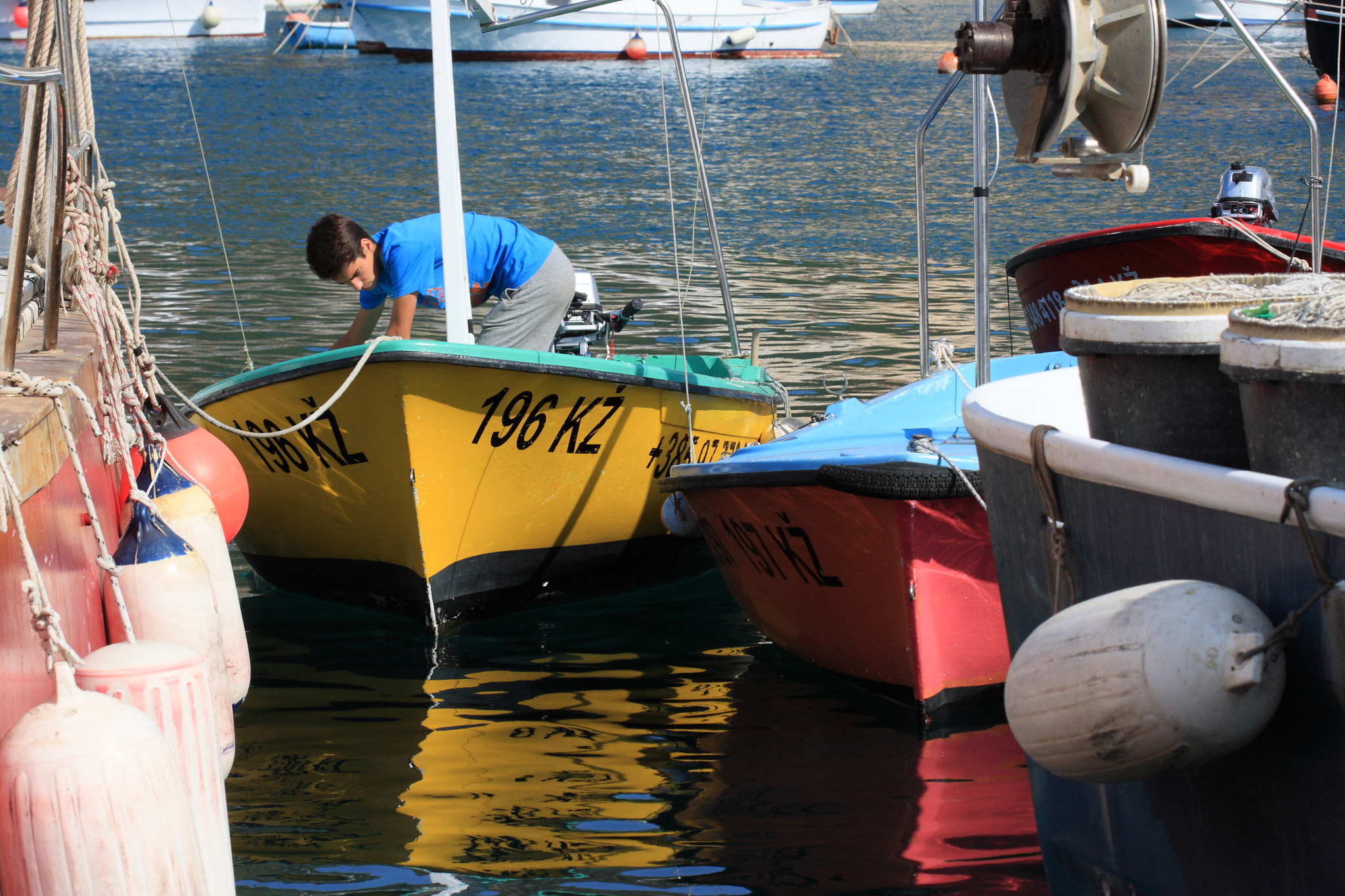 Canon EOS 40D sample photo. Boy parking the boats photography