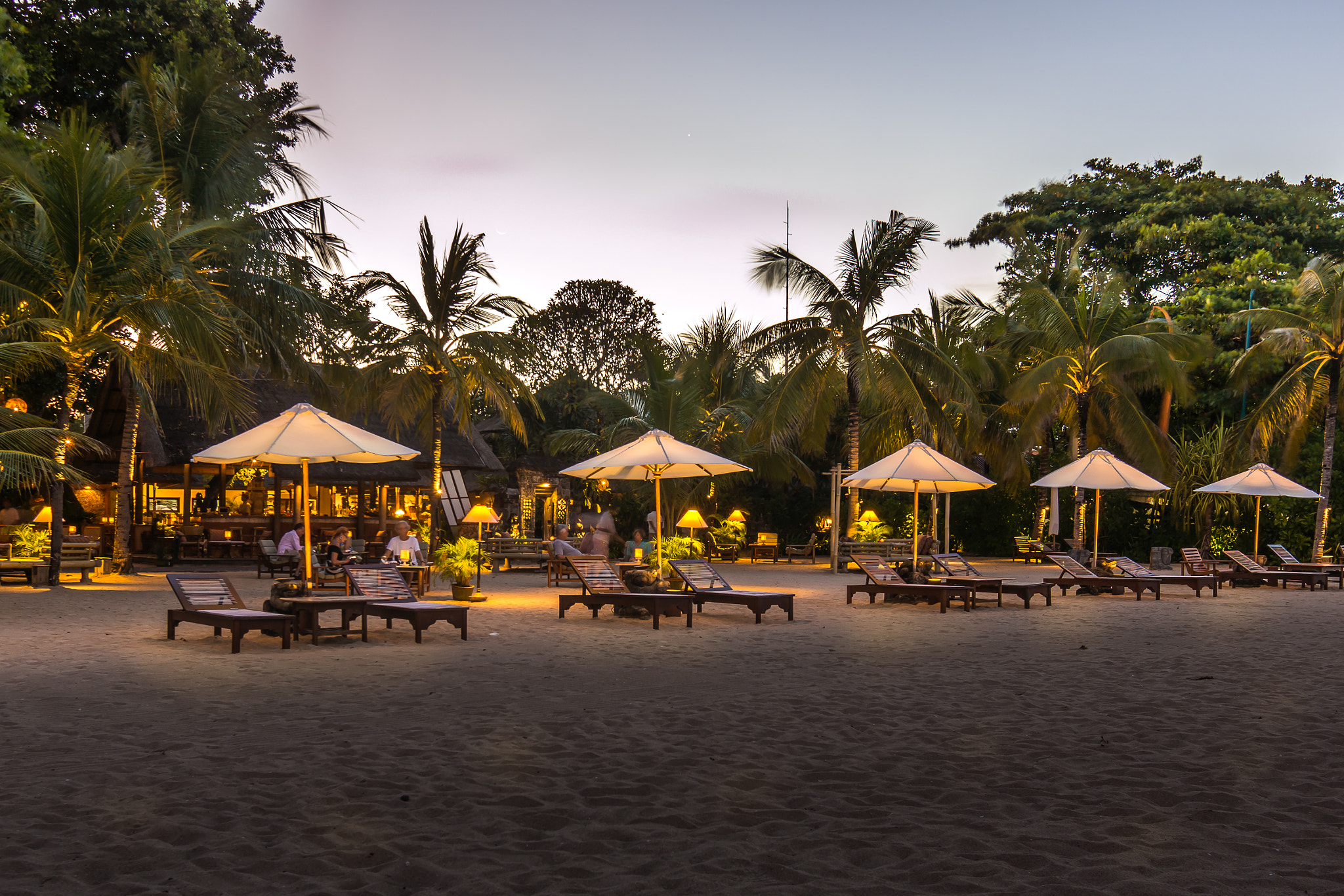 Sony Alpha NEX-7 sample photo. Sunbeds and restaurants  on a balinese beach at night photography