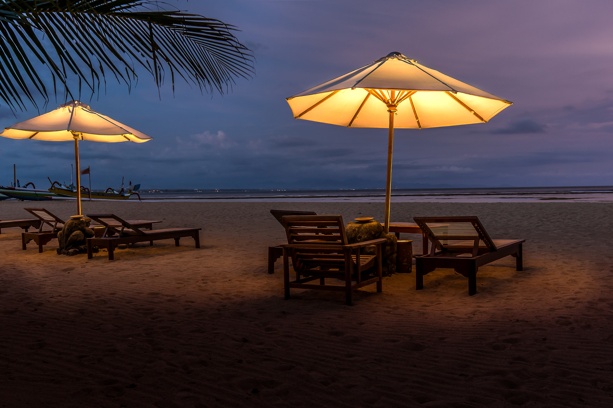 Sony Alpha NEX-7 sample photo. Umbrellas and sunbeds on the beach at night photography