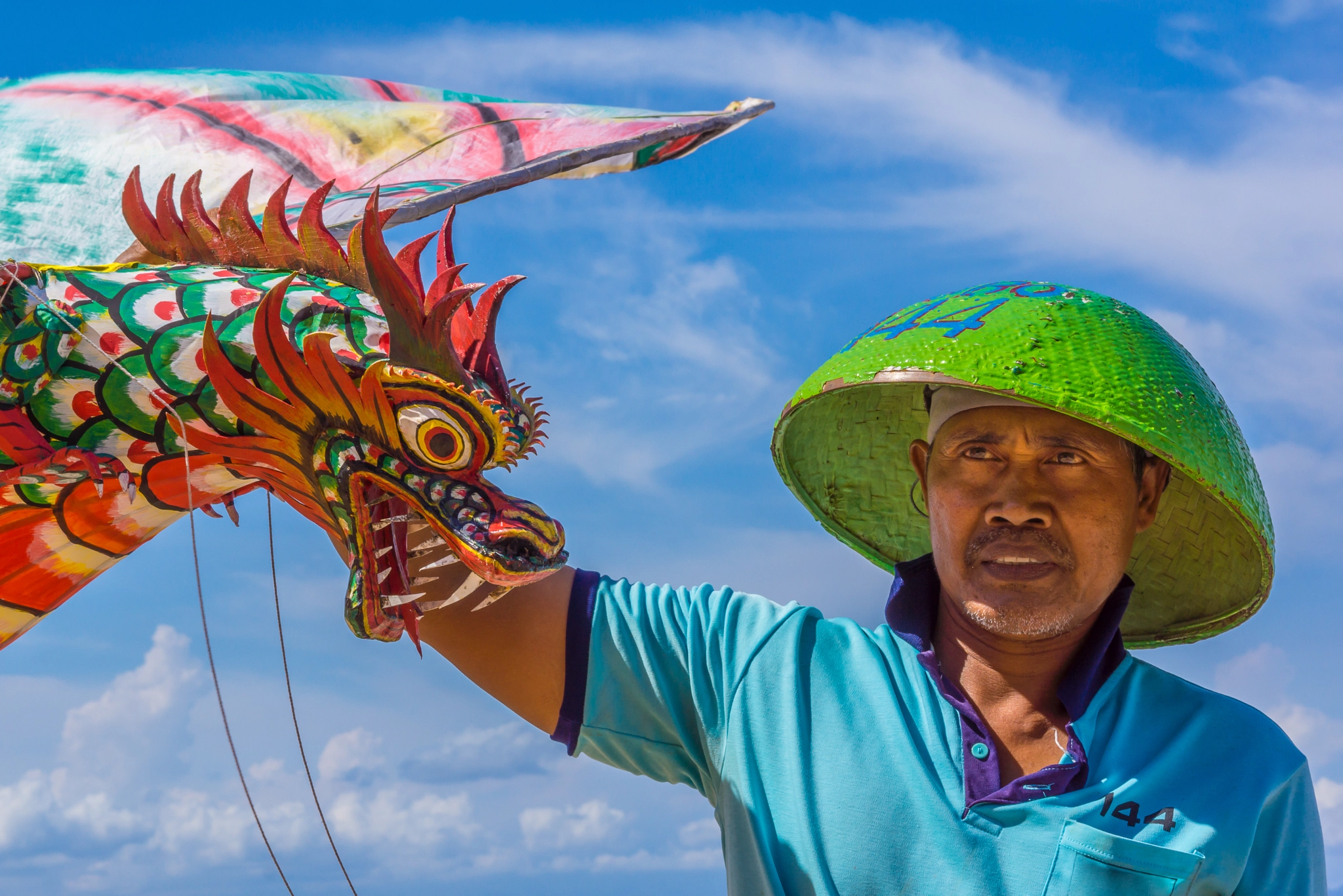 Sony Alpha NEX-7 sample photo. An indonesian man holding a big kite with a dragon head photography