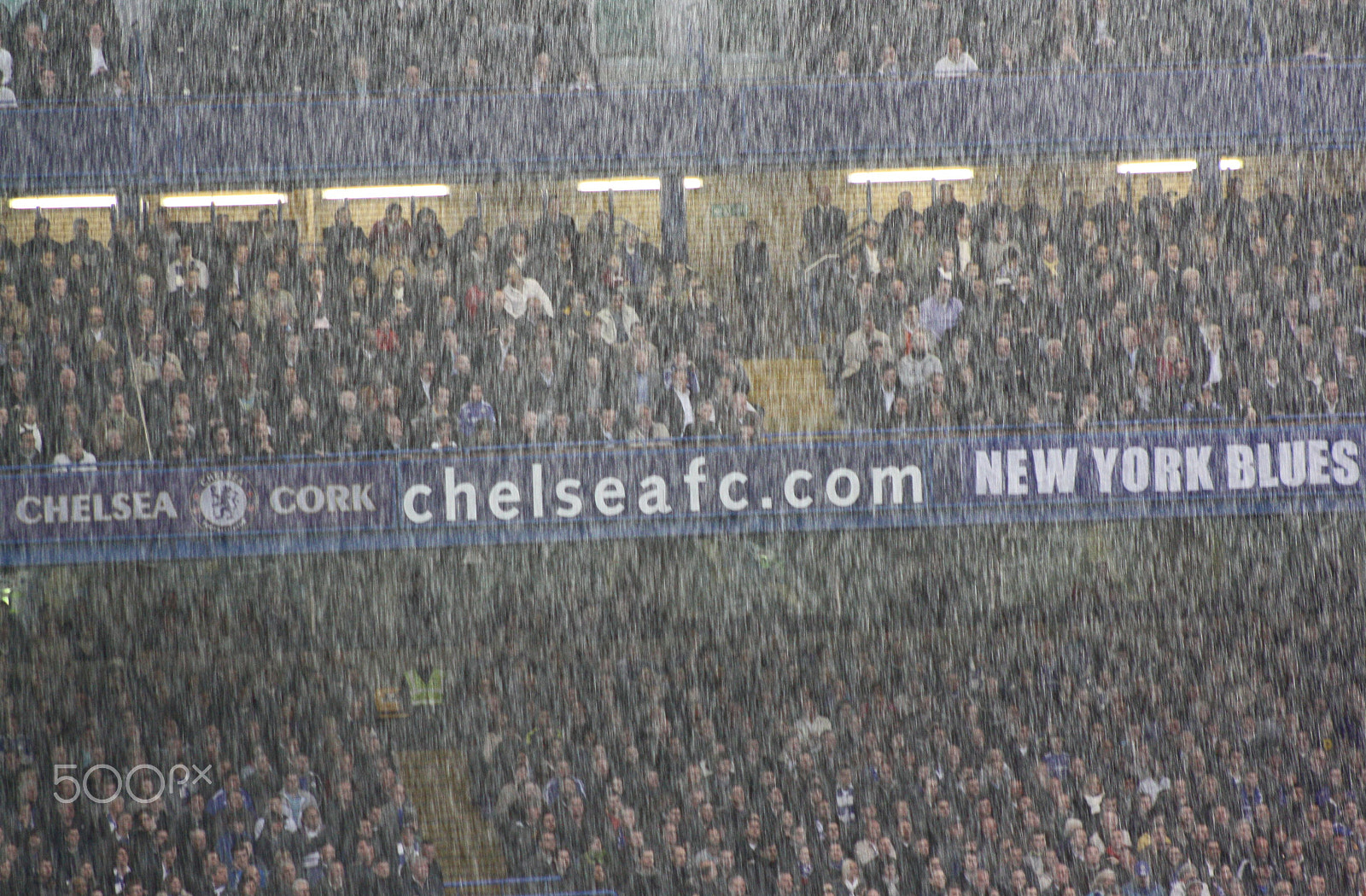 Canon EF 75-300mm f/4-5.6 sample photo. Football in the rain photography