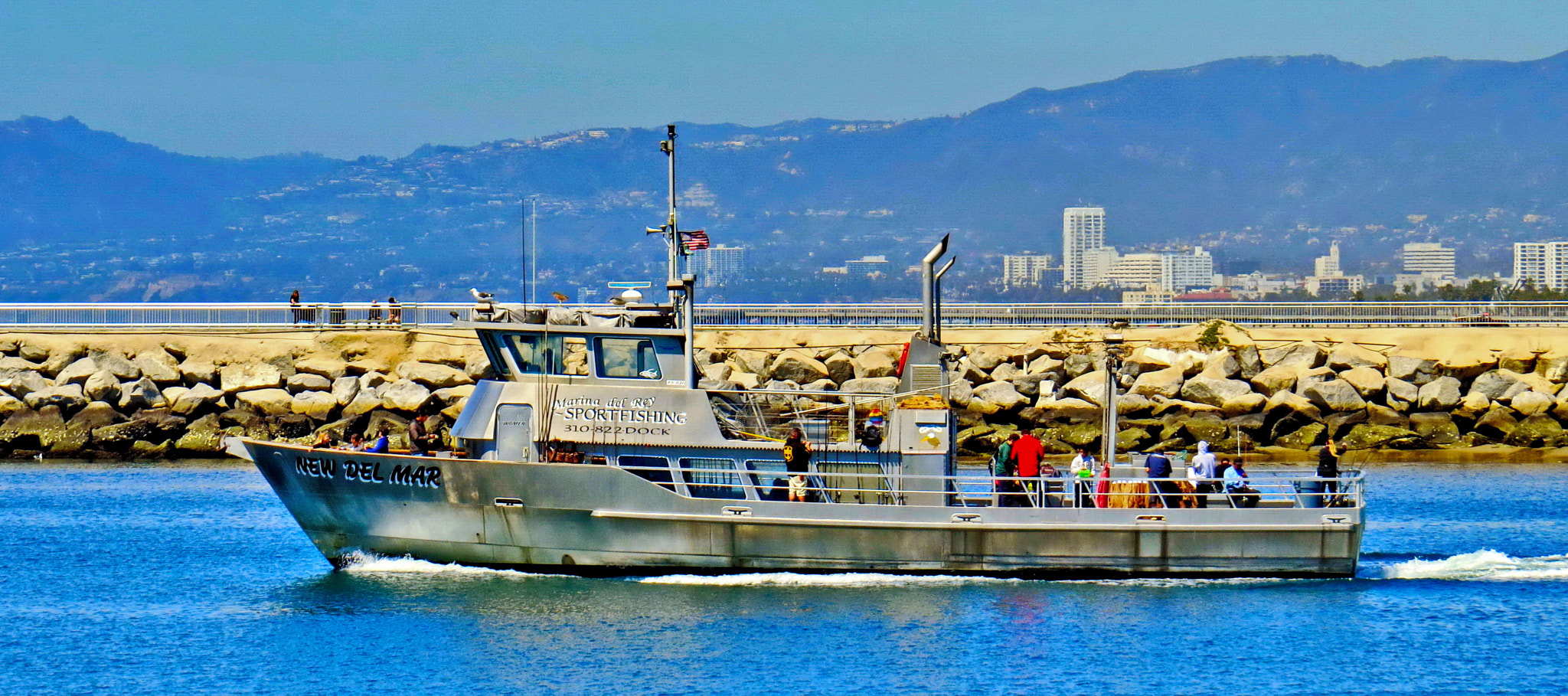 Canon PowerShot SX50 HS + 4.3 - 215.0 mm sample photo. A fishing boat going out to the ocean photography