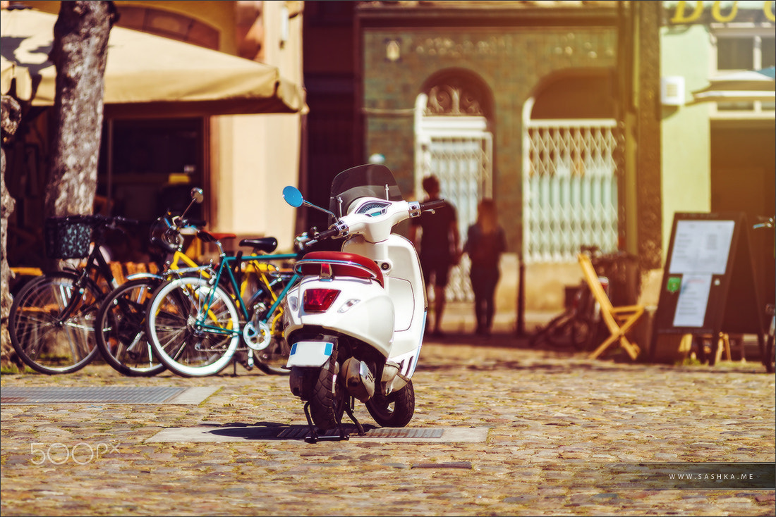 Sony a99 II sample photo. Sunny holidays in old city, vespa scooter on the street photography