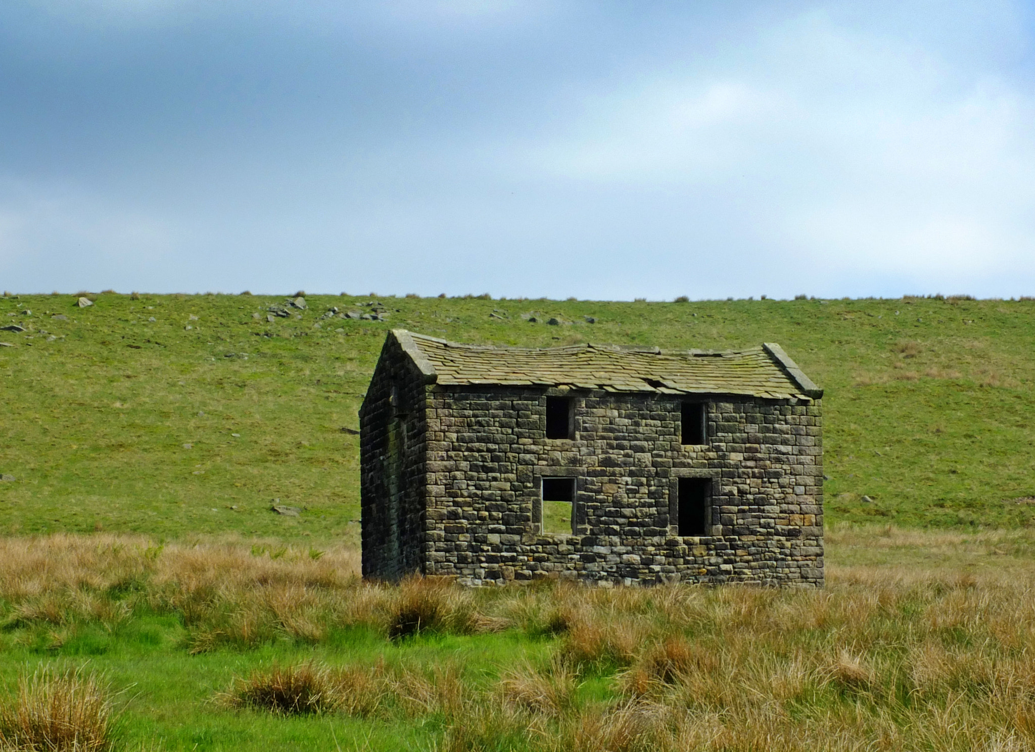 Fujifilm X-S1 sample photo. An old abandoned stone farmhouse in green pasture on high pennine moorland with bright blue sky photography