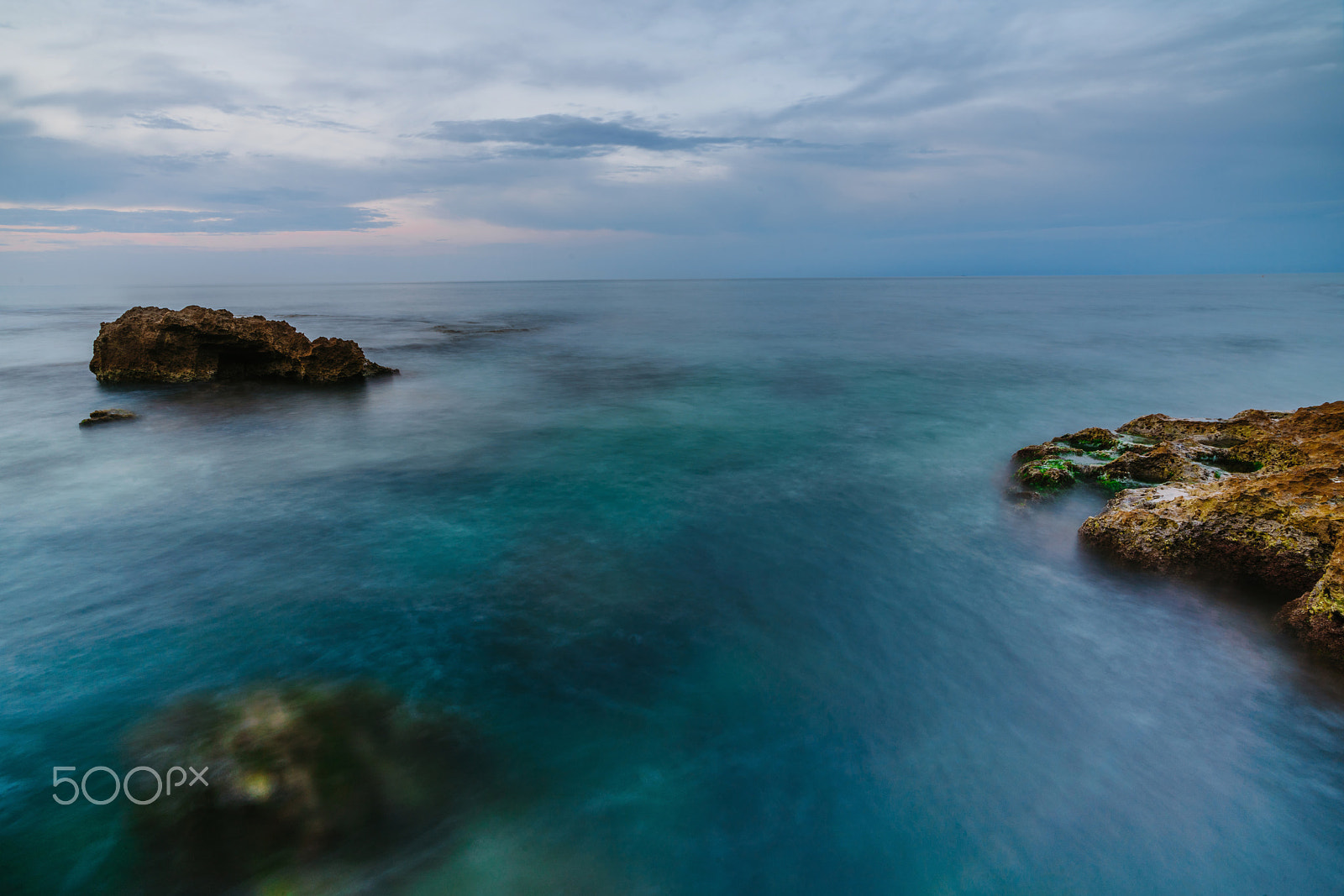Sony a99 II sample photo. Sunset on the beach among the rocks near the city of denia. district of valencia, spain. photography