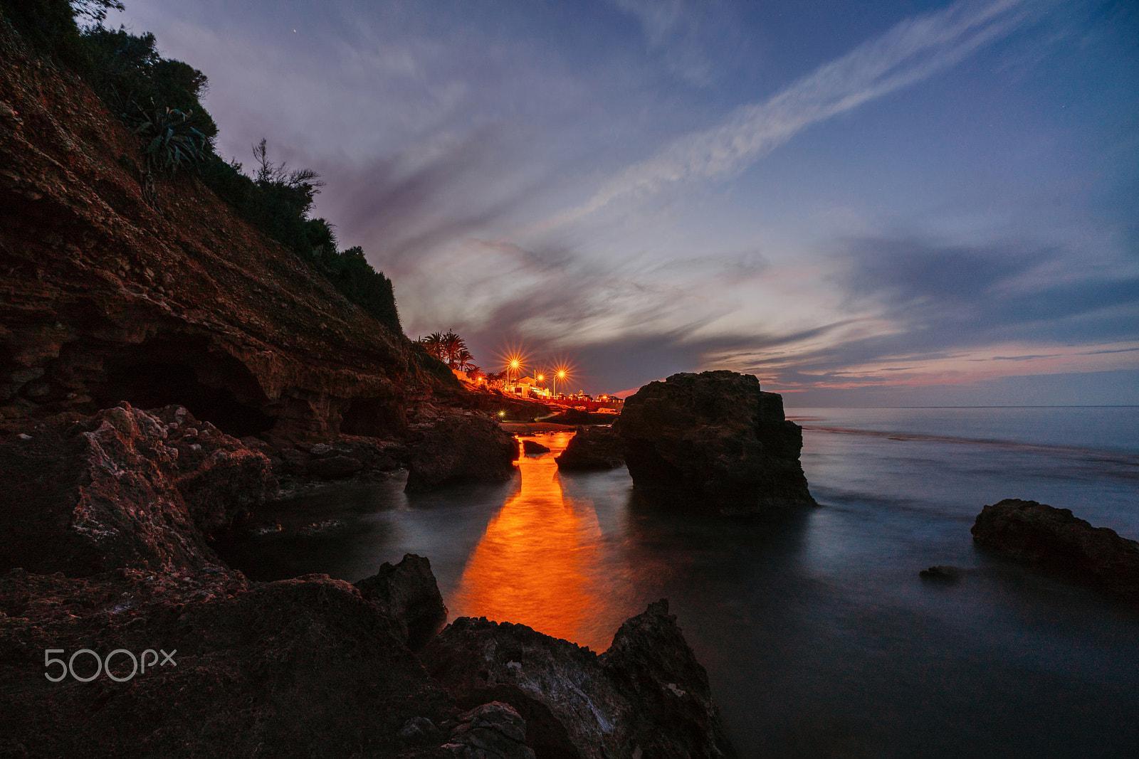 Sony a99 II sample photo. Sunset on the beach among the rocks near the city of denia. district of valencia, spain. photography