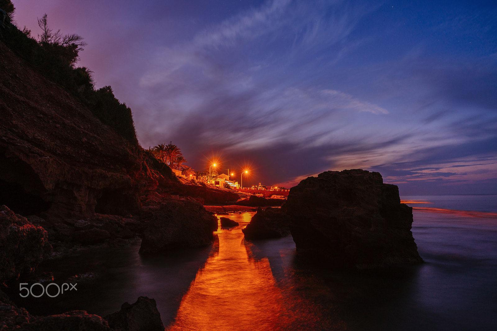 Sony a99 II sample photo. Sunset on the beach among the rocks near the city of denia. district of valencia, spain. photography