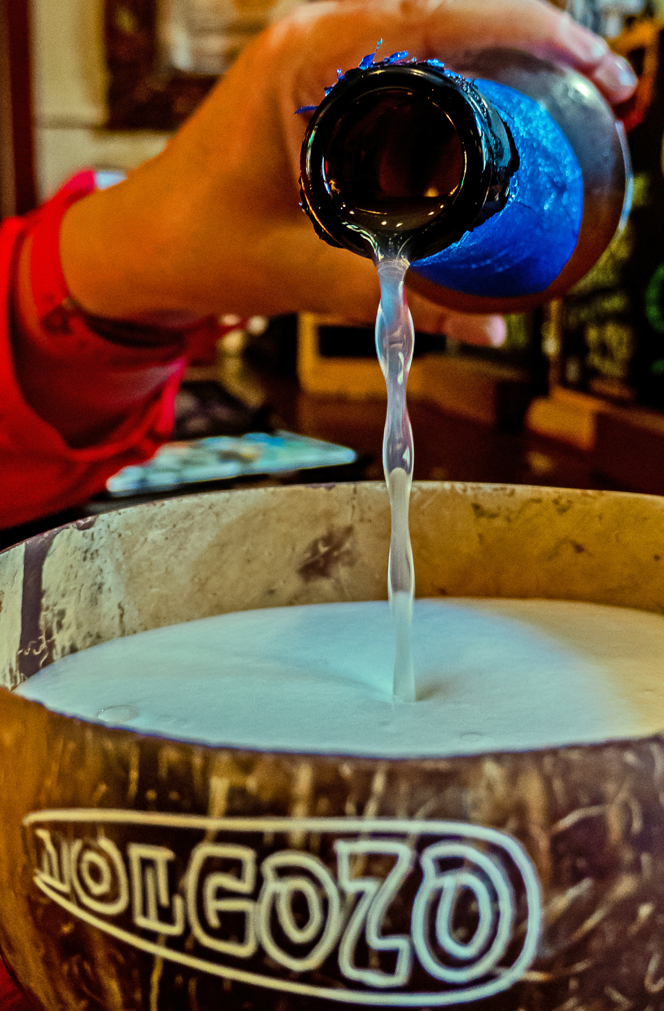 Panasonic DC-TZ200 sample photo. Pouring the mongozo coconut beer photography
