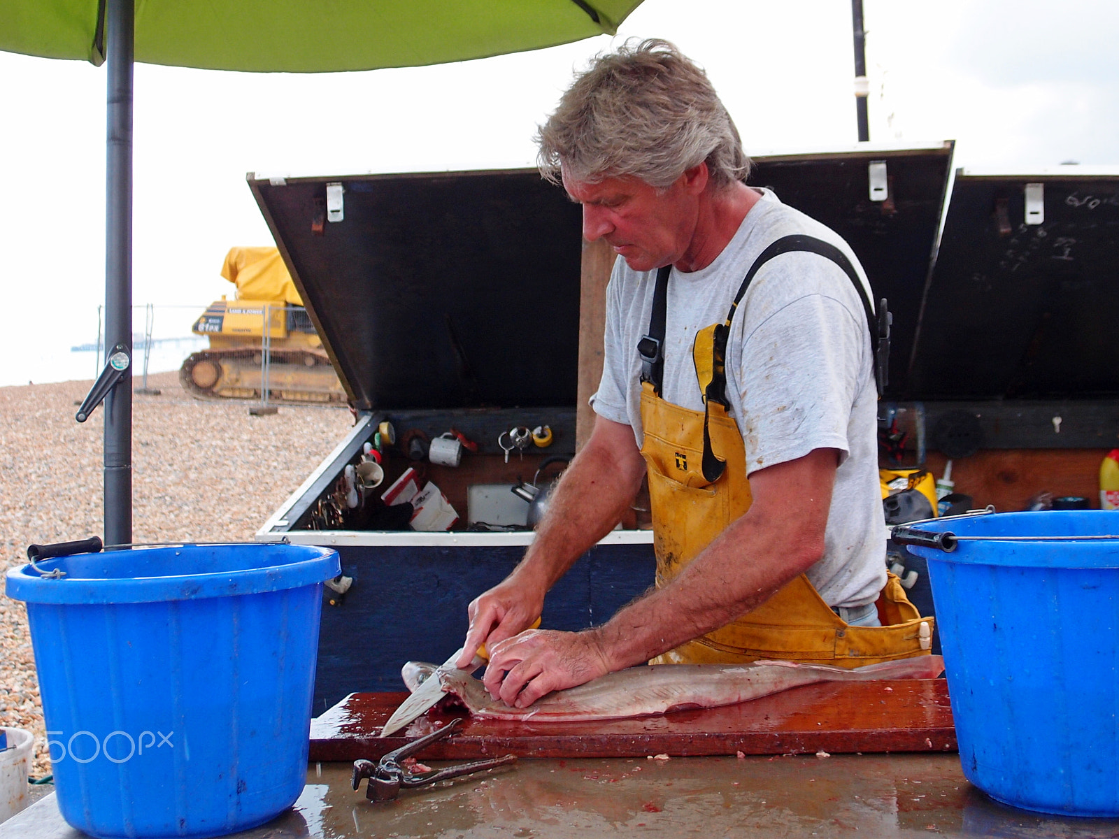 Olympus XZ-1 sample photo. Fisherman prepares fish for sale photography
