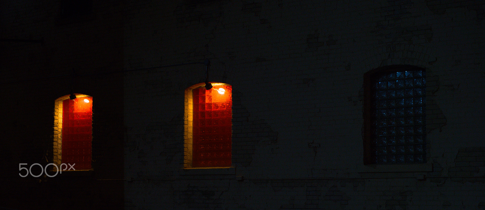 Sony a7R III sample photo. Three dimly lit windows at night photography