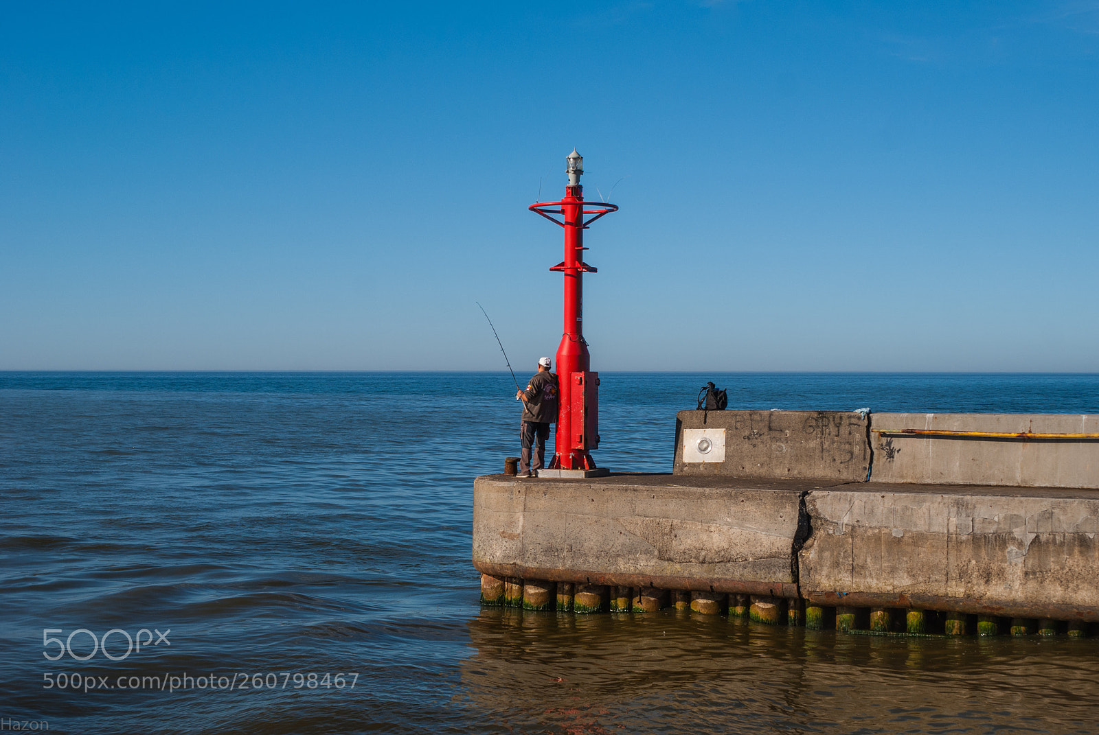 Sony Alpha DSLR-A200 sample photo. Fisherman on breakwater photography