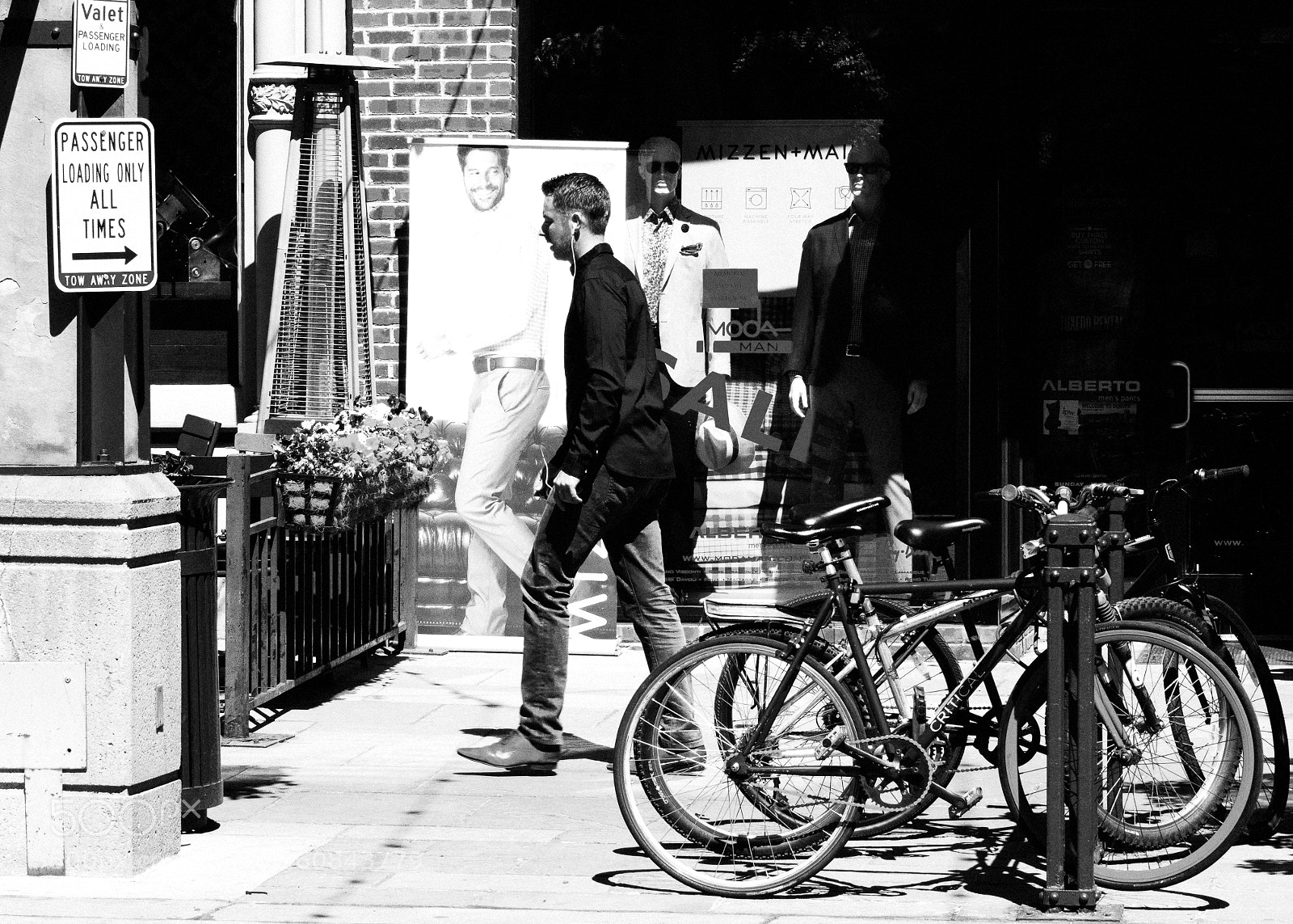 Sony a6500 sample photo. Man walking between bicycles photography