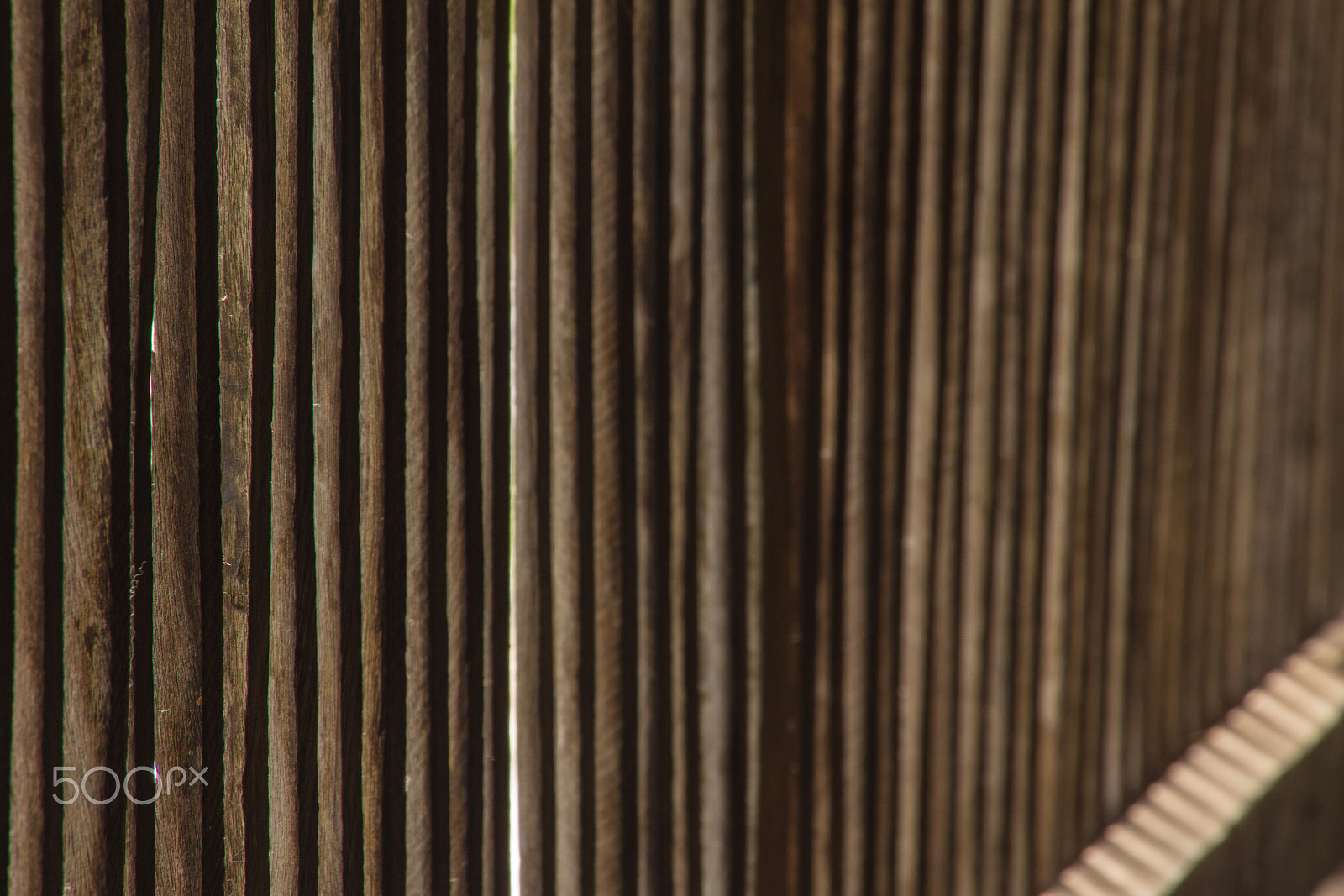 Canon EOS M sample photo. Old wooden vertical planks with horizontal slats left side focus photography