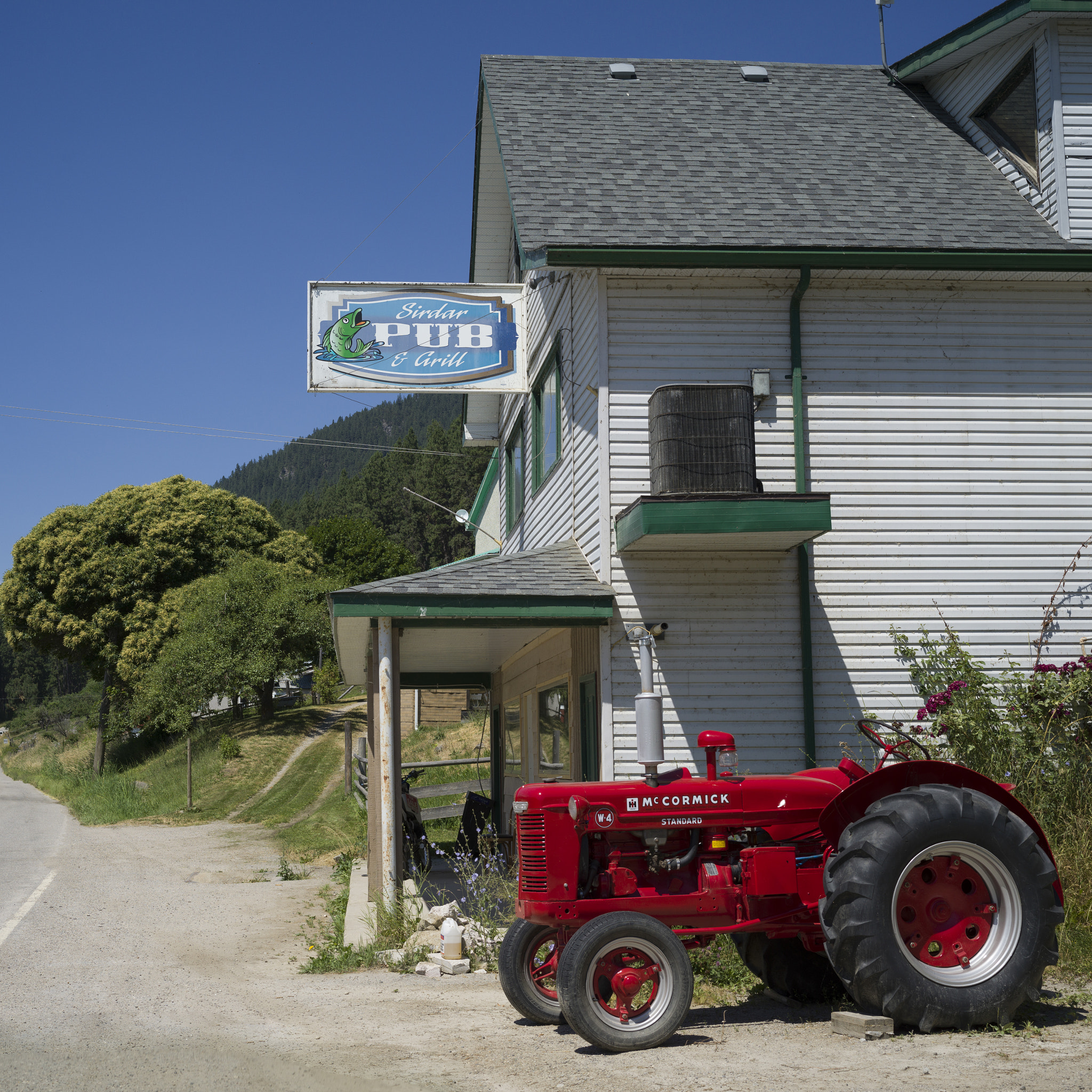 Hasselblad X1D-50c sample photo. Tractor parked next to a pub, sirdar, near creston, british colu photography