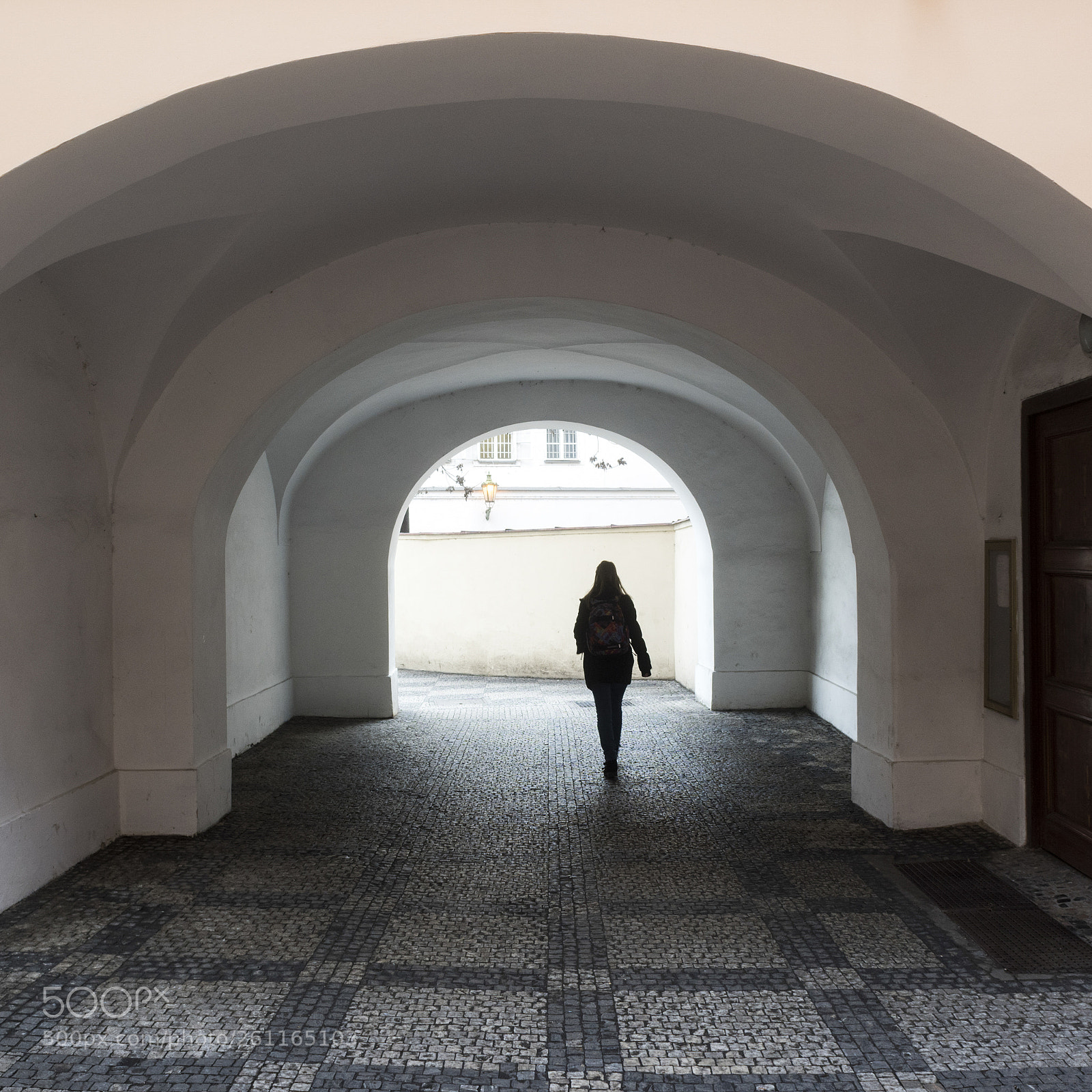 Nikon D810 sample photo. Woman walking on cobblestone photography