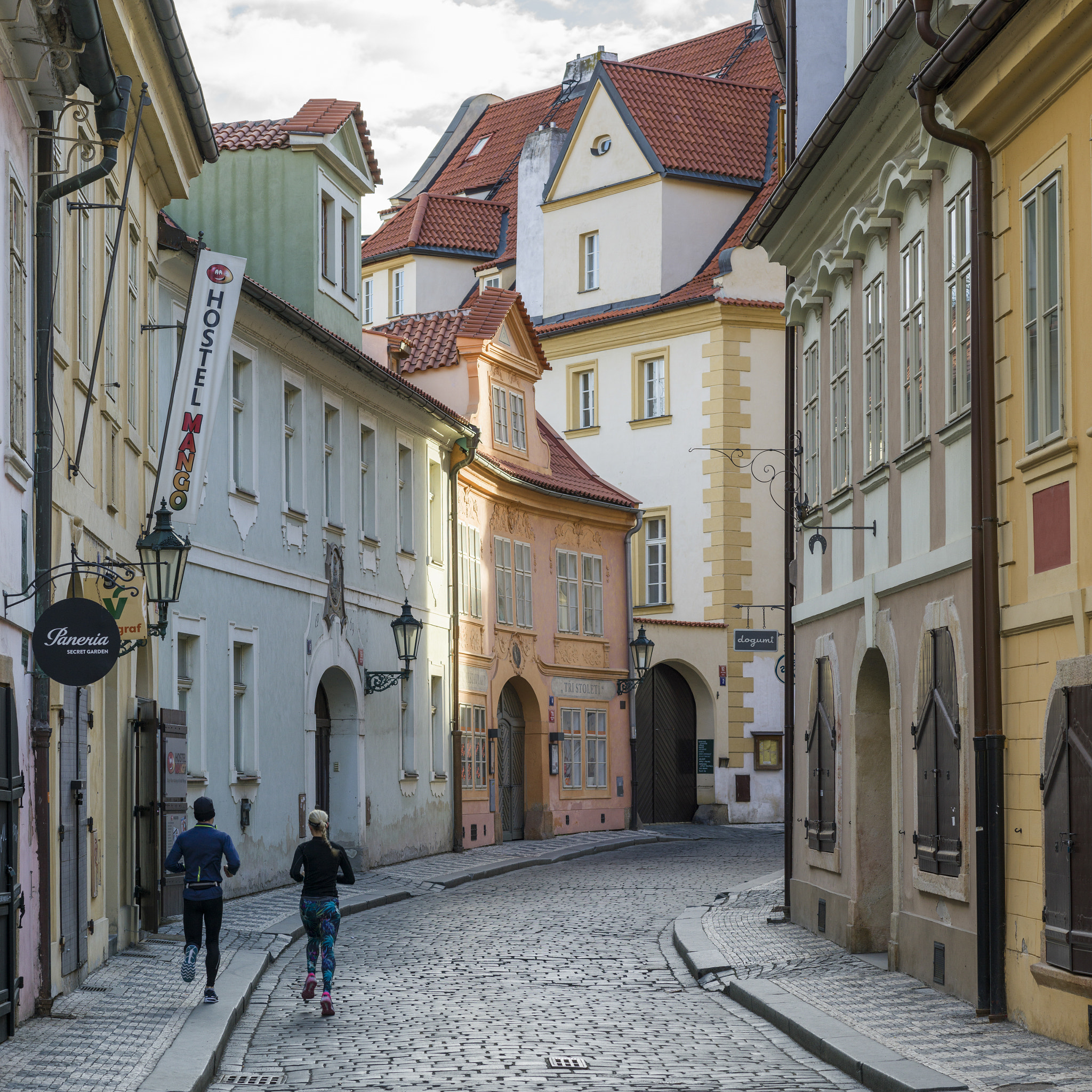 Hasselblad X1D-50c sample photo. Rear view of man and woman running on a city street, prague, cze photography