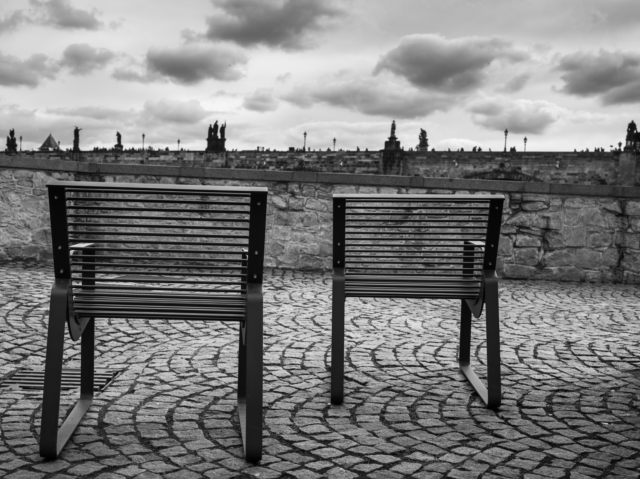 Hasselblad X1D-50c sample photo. Chairs at kampa island with charles bridge in background, prague photography