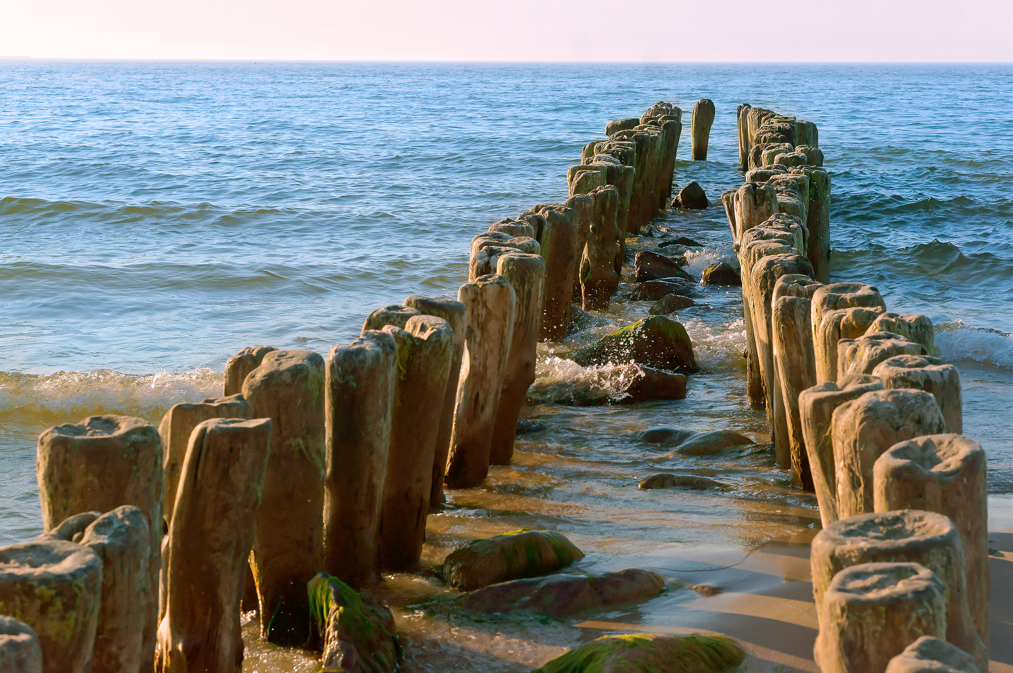 Sony Alpha NEX-3N sample photo. The groynes in the sea, a breakwater made of wood, sea waves protection from photography