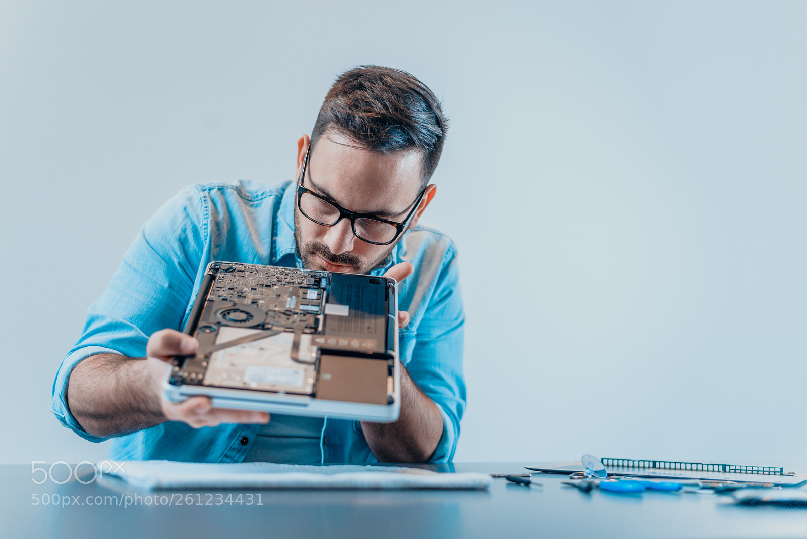 Nikon D610 sample photo. Technician examining laptop parts. photography