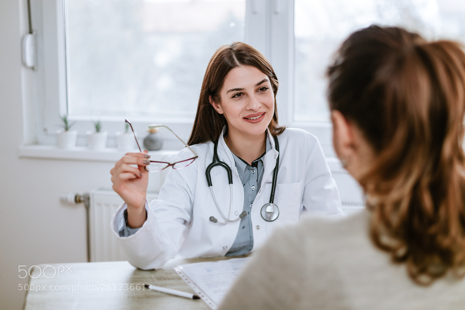 Nikon D610 sample photo. Smiling doctor holding eyeglasses photography