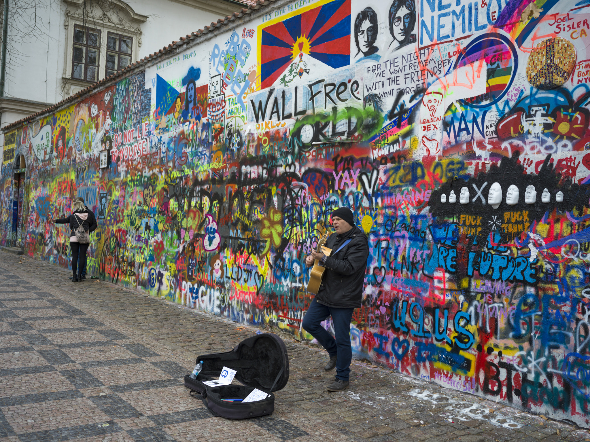 Hasselblad X1D-50c sample photo. Street performer in front of graffiti covered wall, john lennon photography