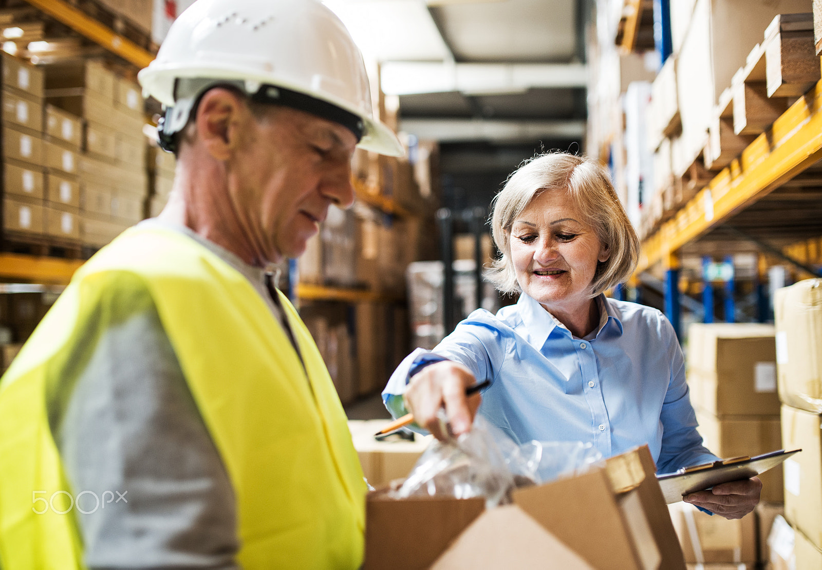 Nikon D4S sample photo. Senior woman manager and man worker working in a warehouse. photography