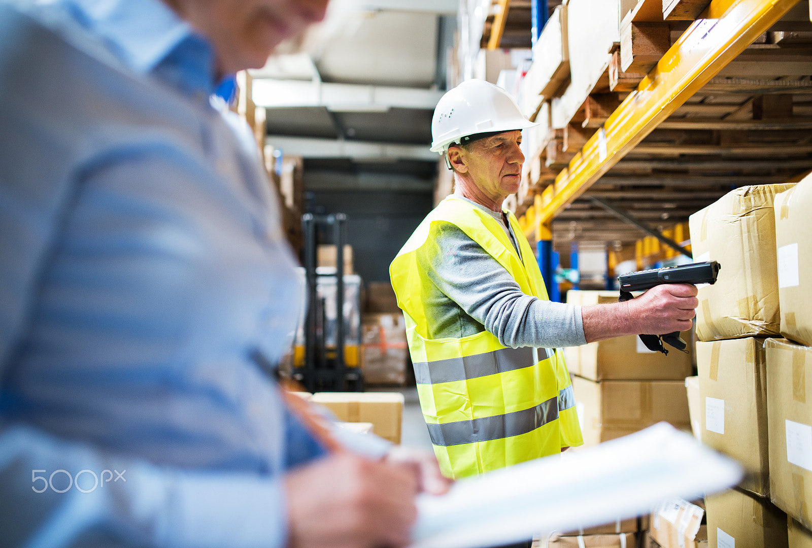 Nikon D4S sample photo. Senior woman manager and man worker working in a warehouse. photography