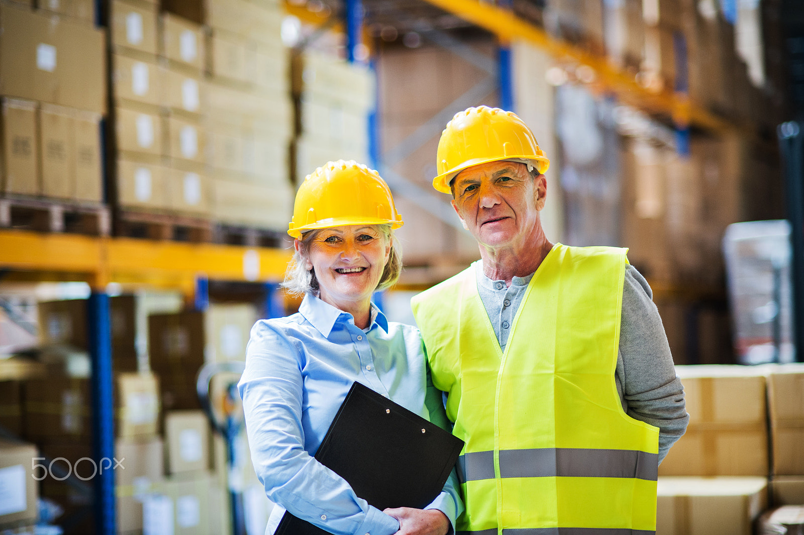 Nikon D4S sample photo. Senior woman manager and man worker standing in a warehouse. photography