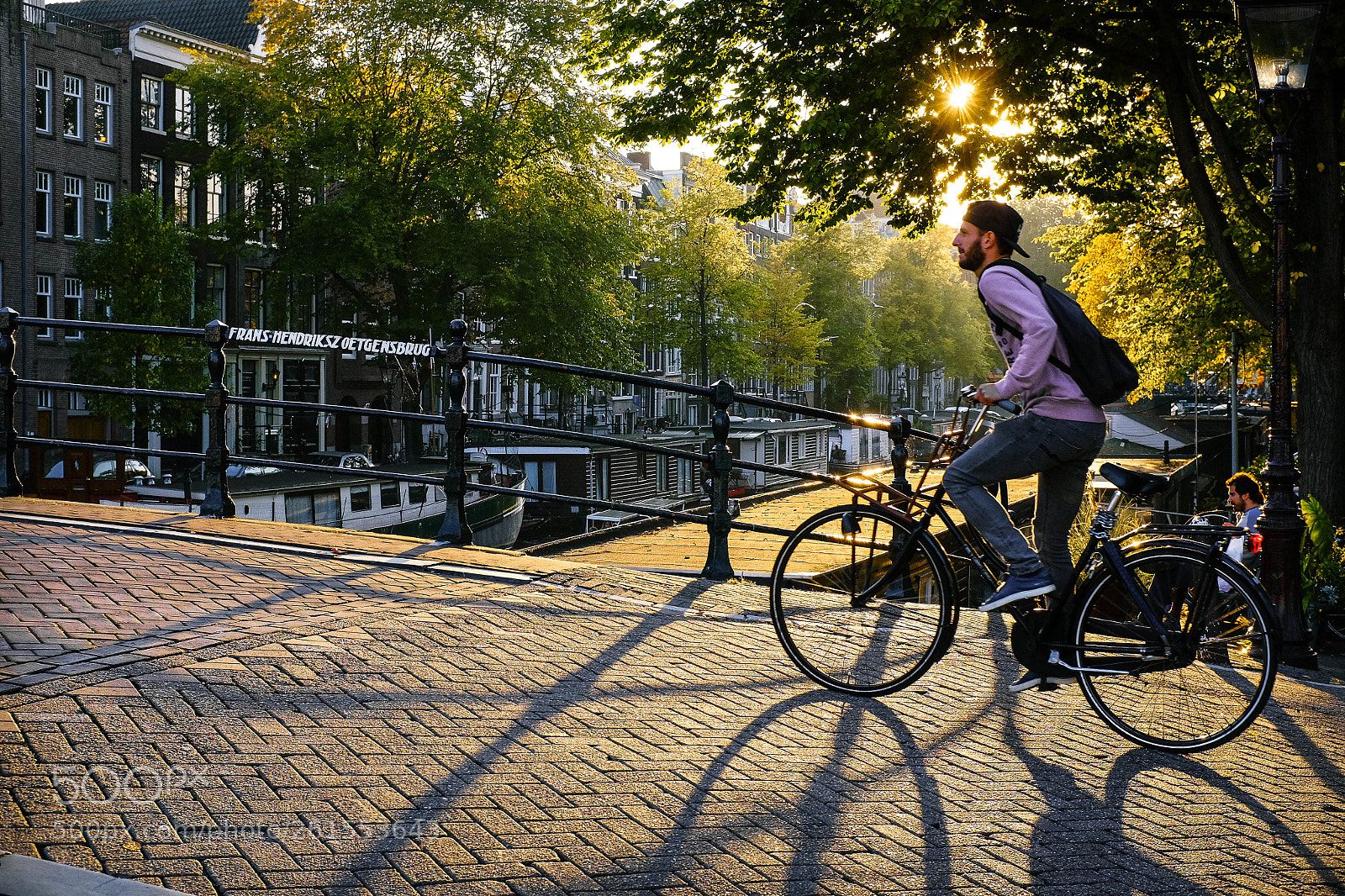 Fujifilm X100T sample photo. Cyclist in amsterdam photography