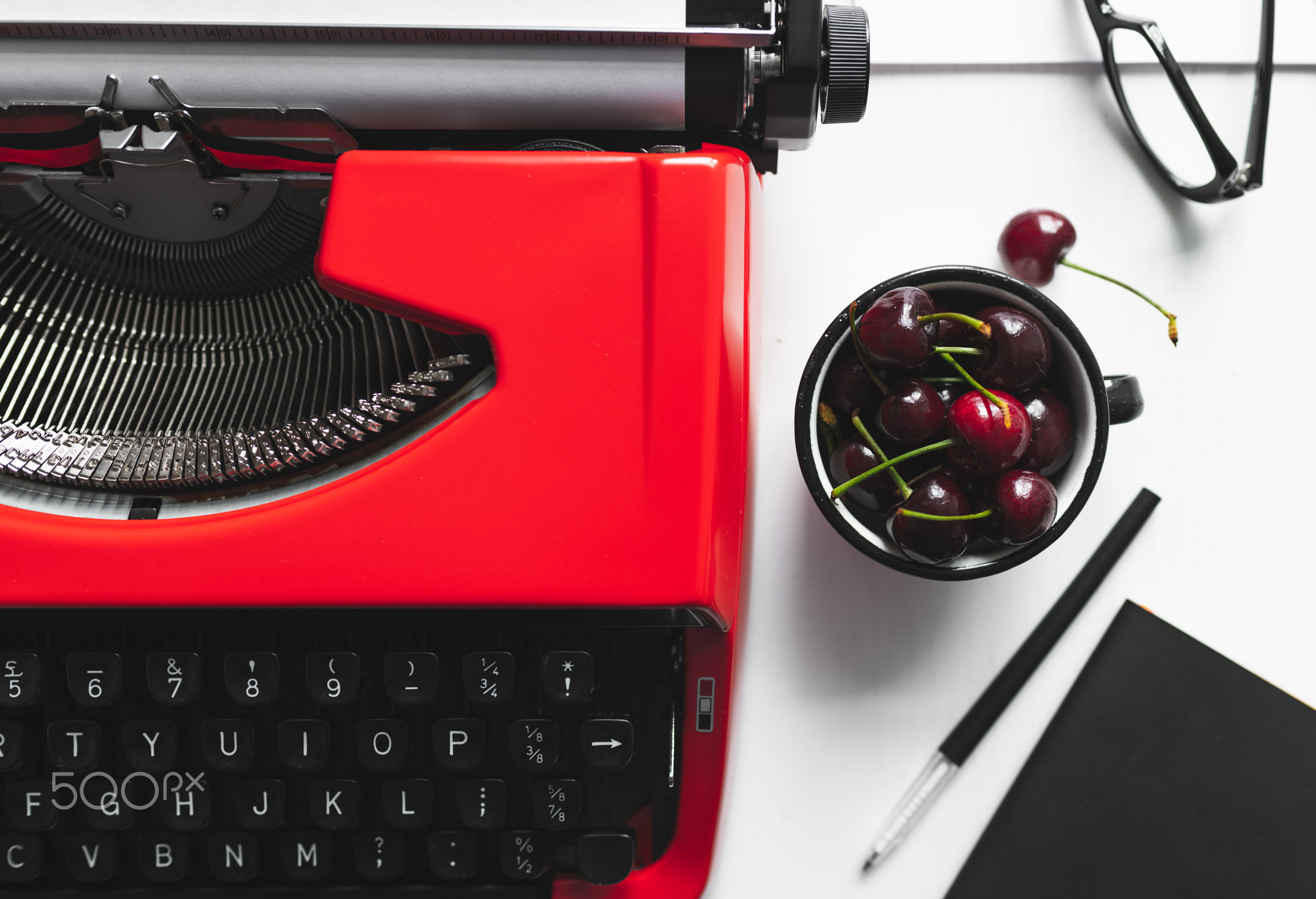 Workplace with bright red vintage typewriter
