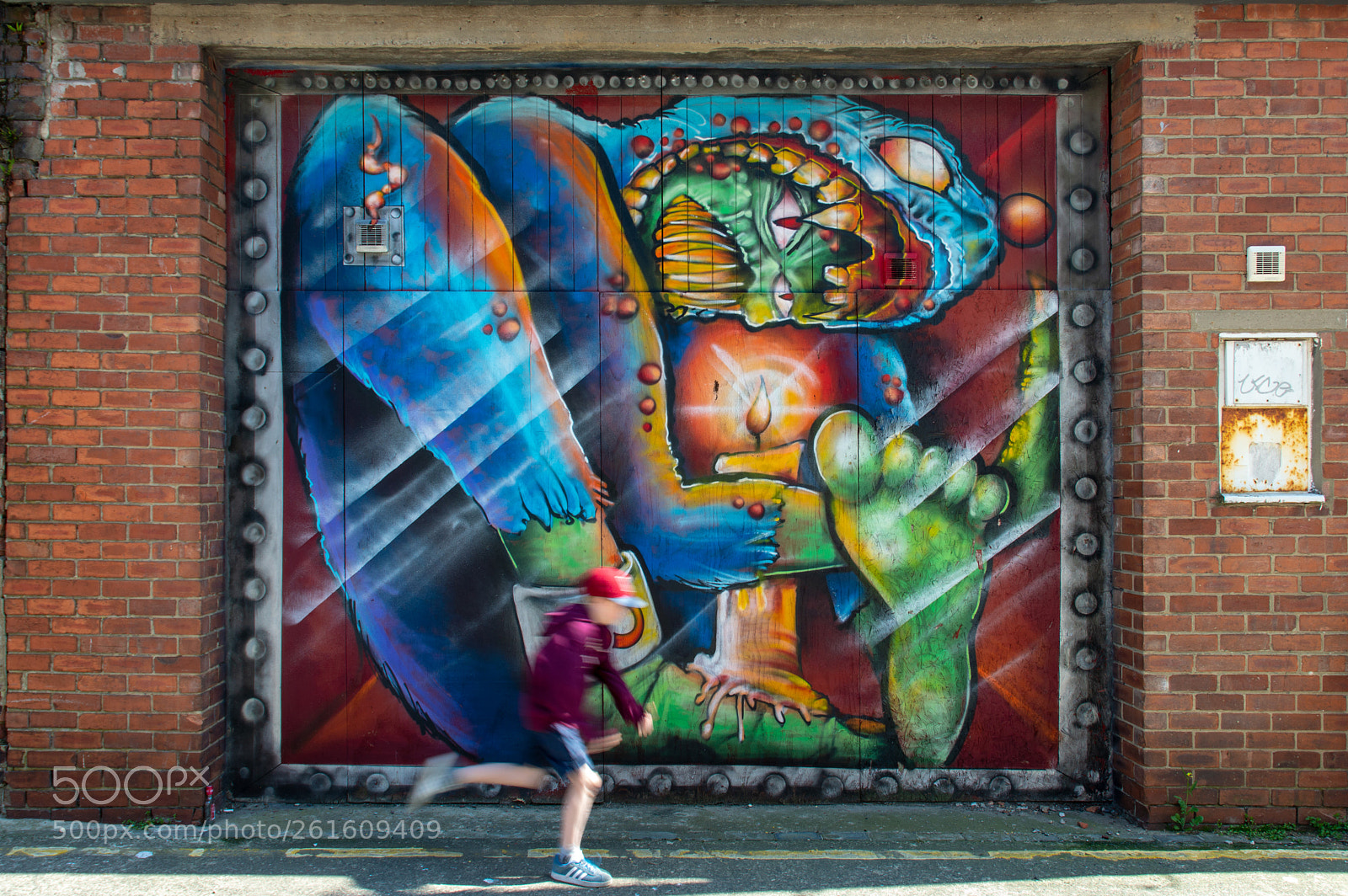 Nikon D3200 sample photo. Boy running past graffiti photography