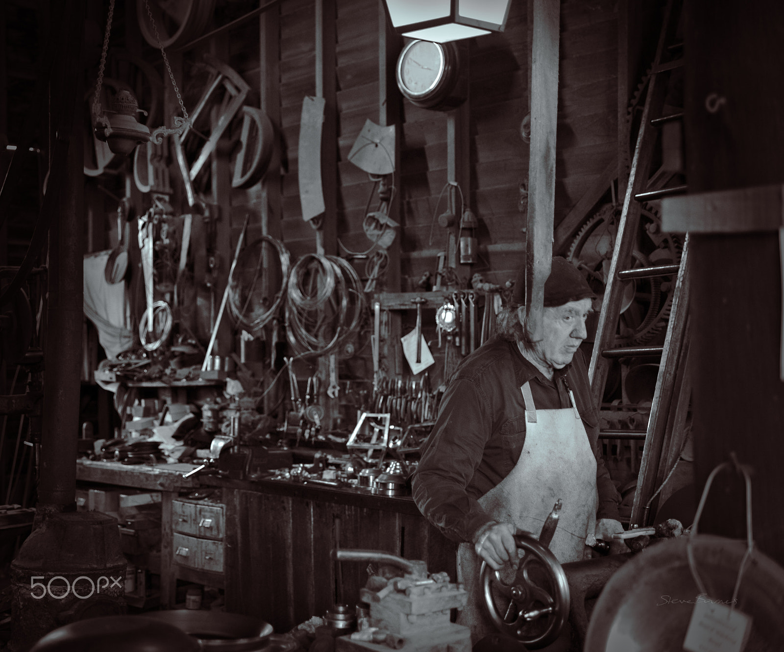 Pentax K-1 sample photo. The ironmonger works amidst a shed full of tools and creations see sovereignhill.com.au photography