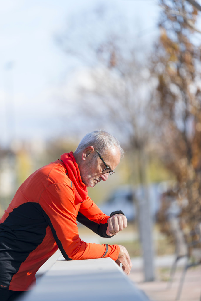 Senior runner man resting at the park while monitoring his exerc by 2Design bcn on 500px.com