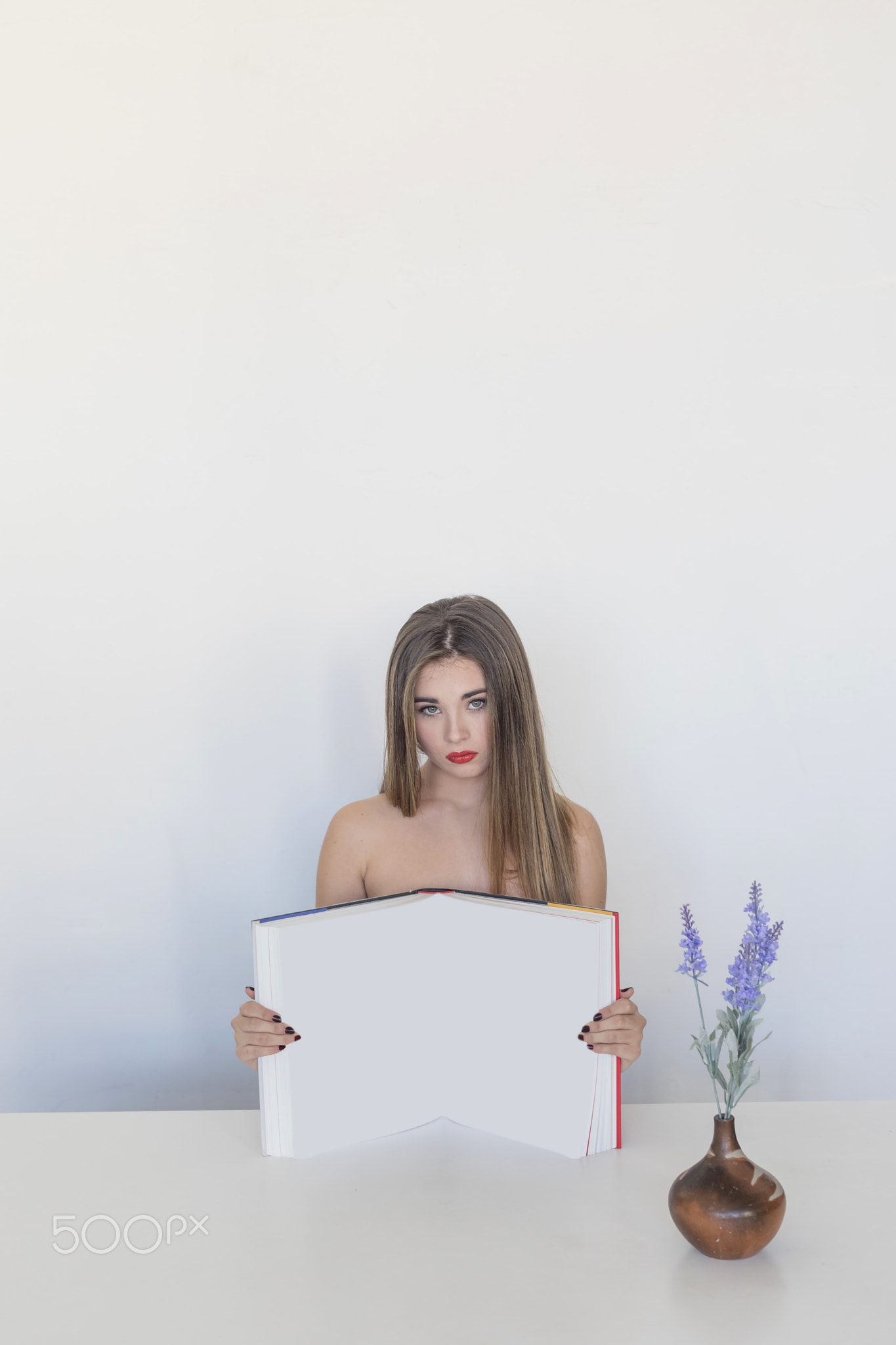 Beautiful woman showing a blank open book
