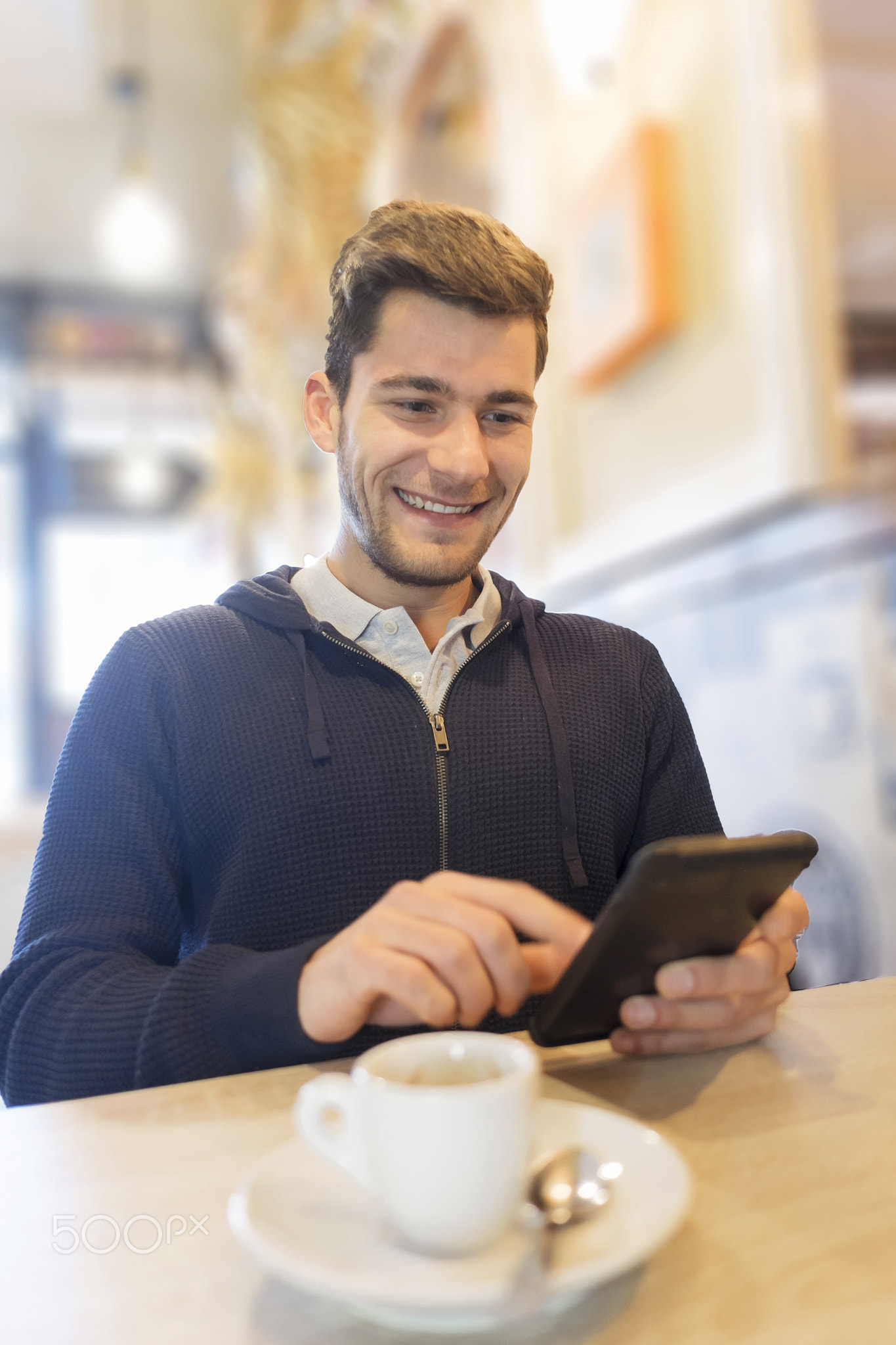 Man having video chat on smart phone at cafe