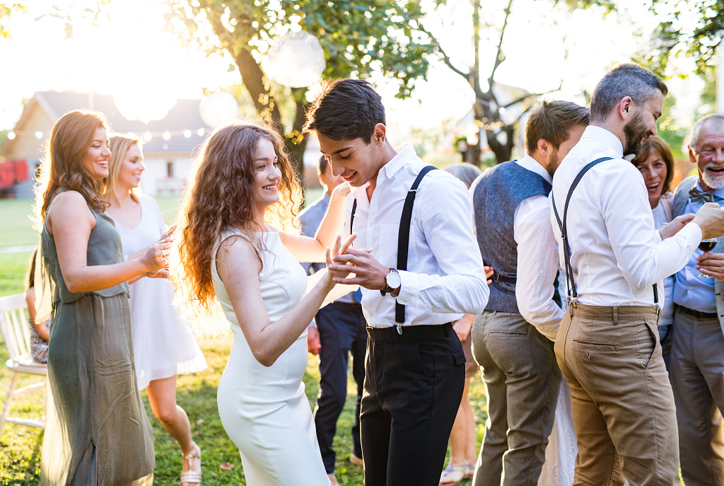 Guests dancing at wedding reception outside in the backyard. by Jozef Polc on 500px.com