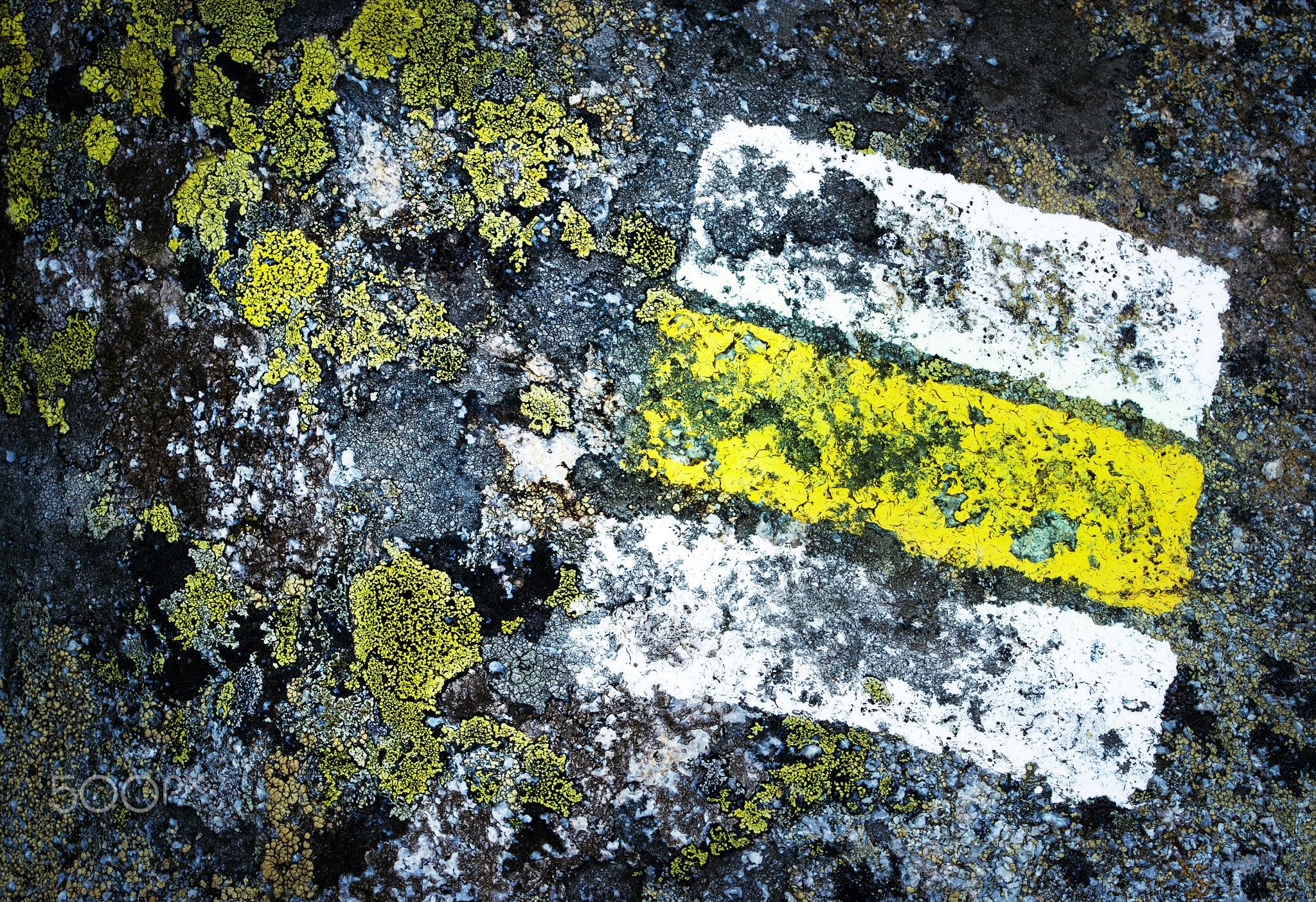 detail yellow tourist sign on granite