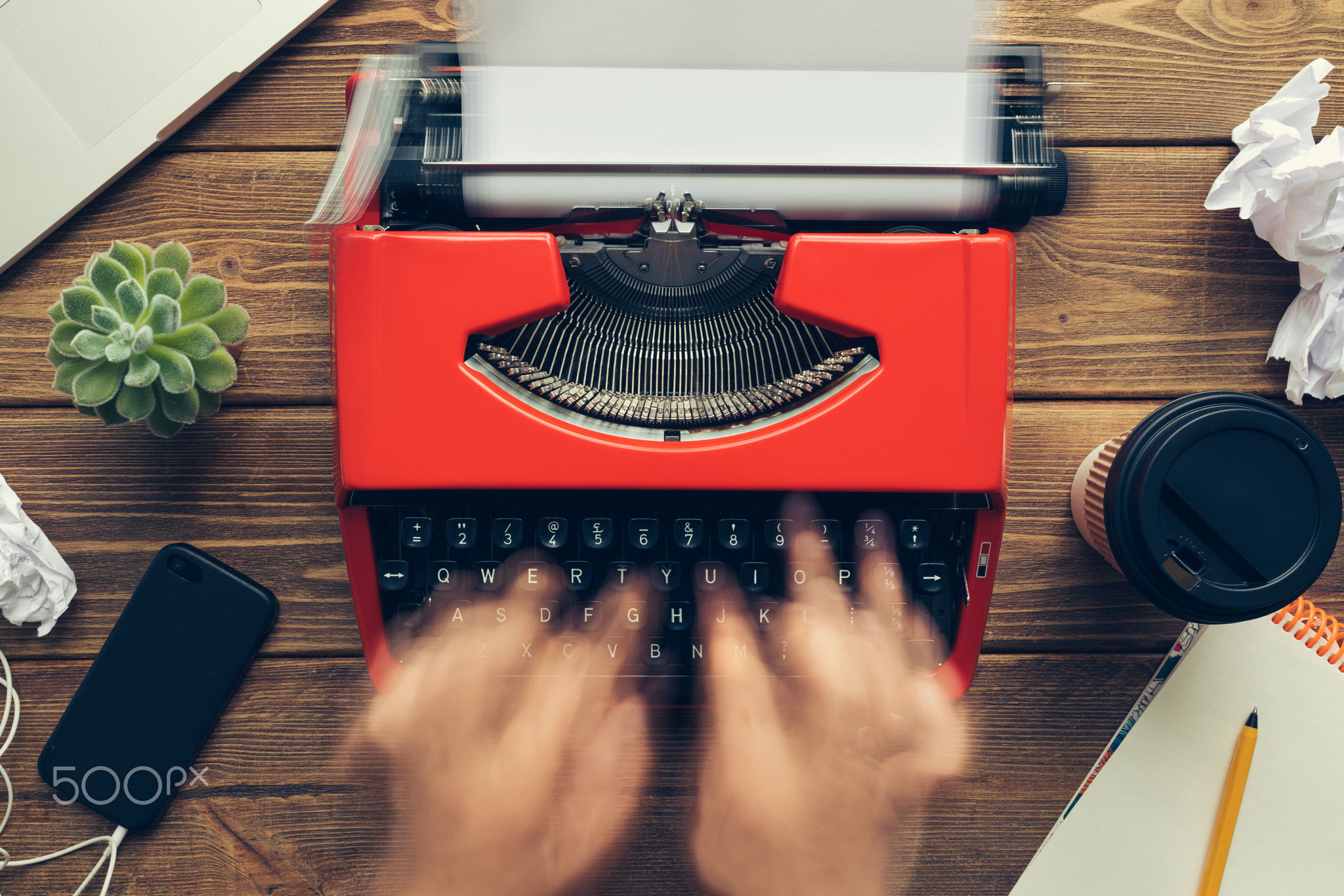 Top view of man using typewriter