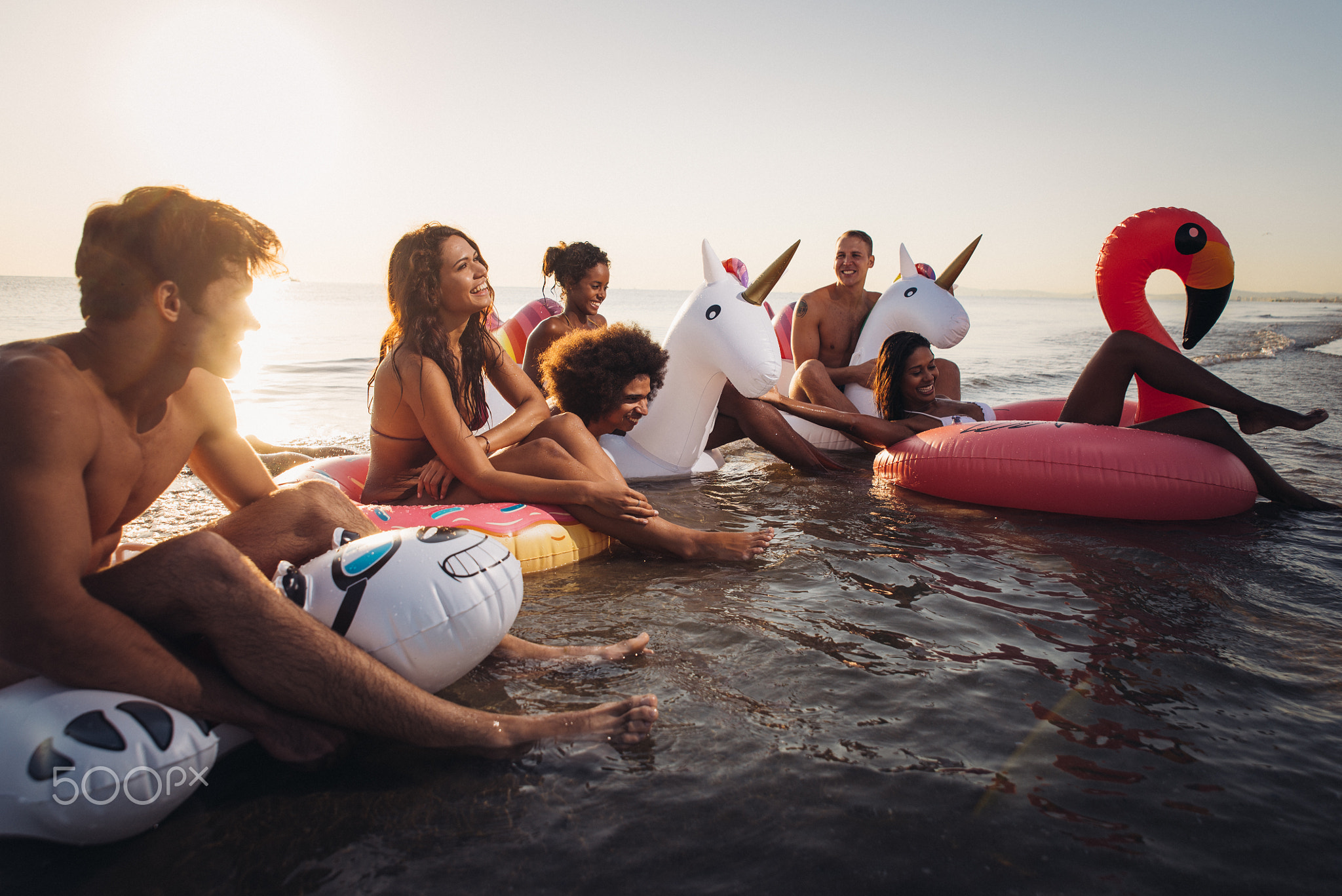 Group of friends having fun on the beach