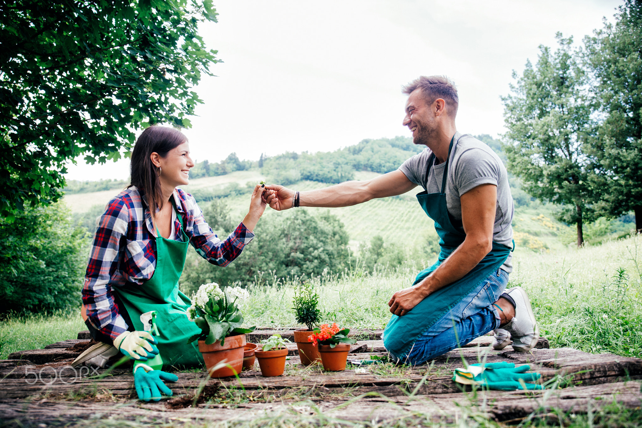 Couple relaxing and planting some flowers in their countryside h