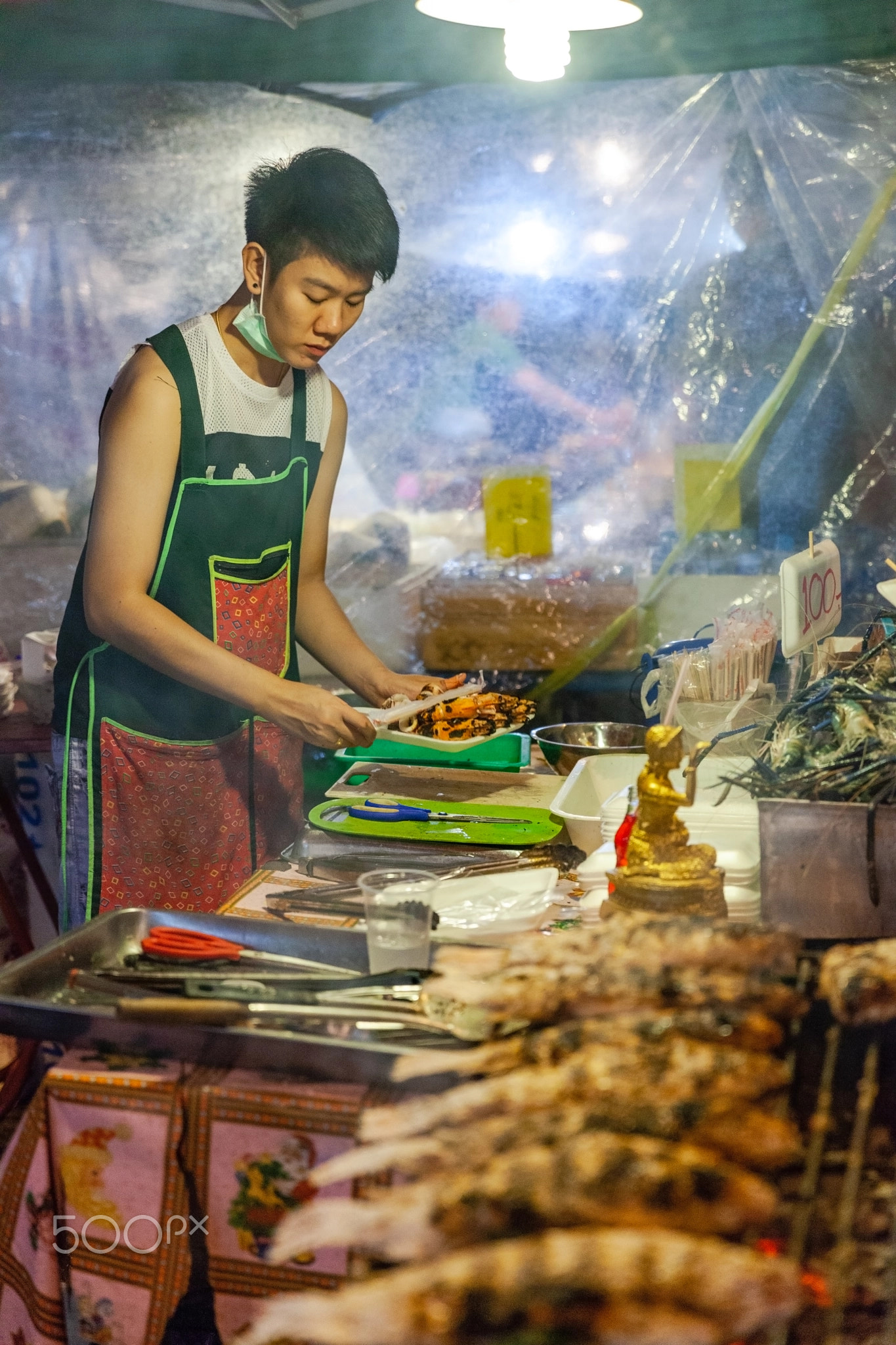 Young woman prepares seafood for sale