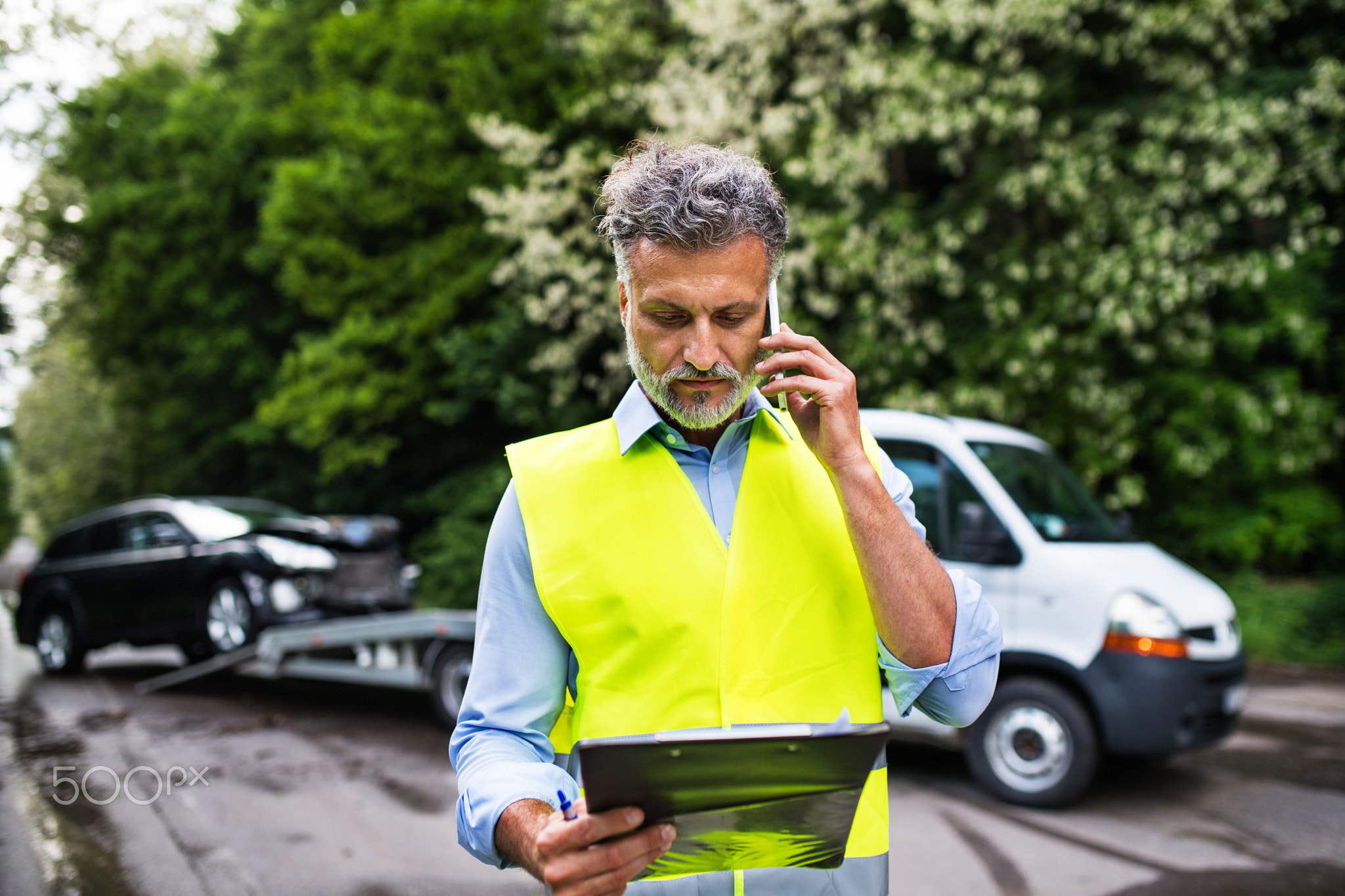 Mature man making a phone call after a car accident. Copy space.