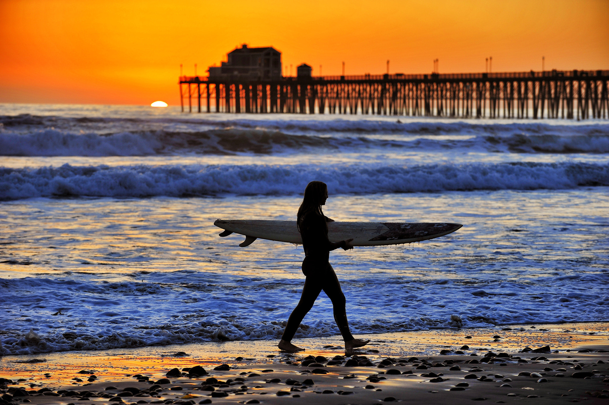 A Female Surfer Heads Home at Sunset in Oceanside - February 21, 2013 ...