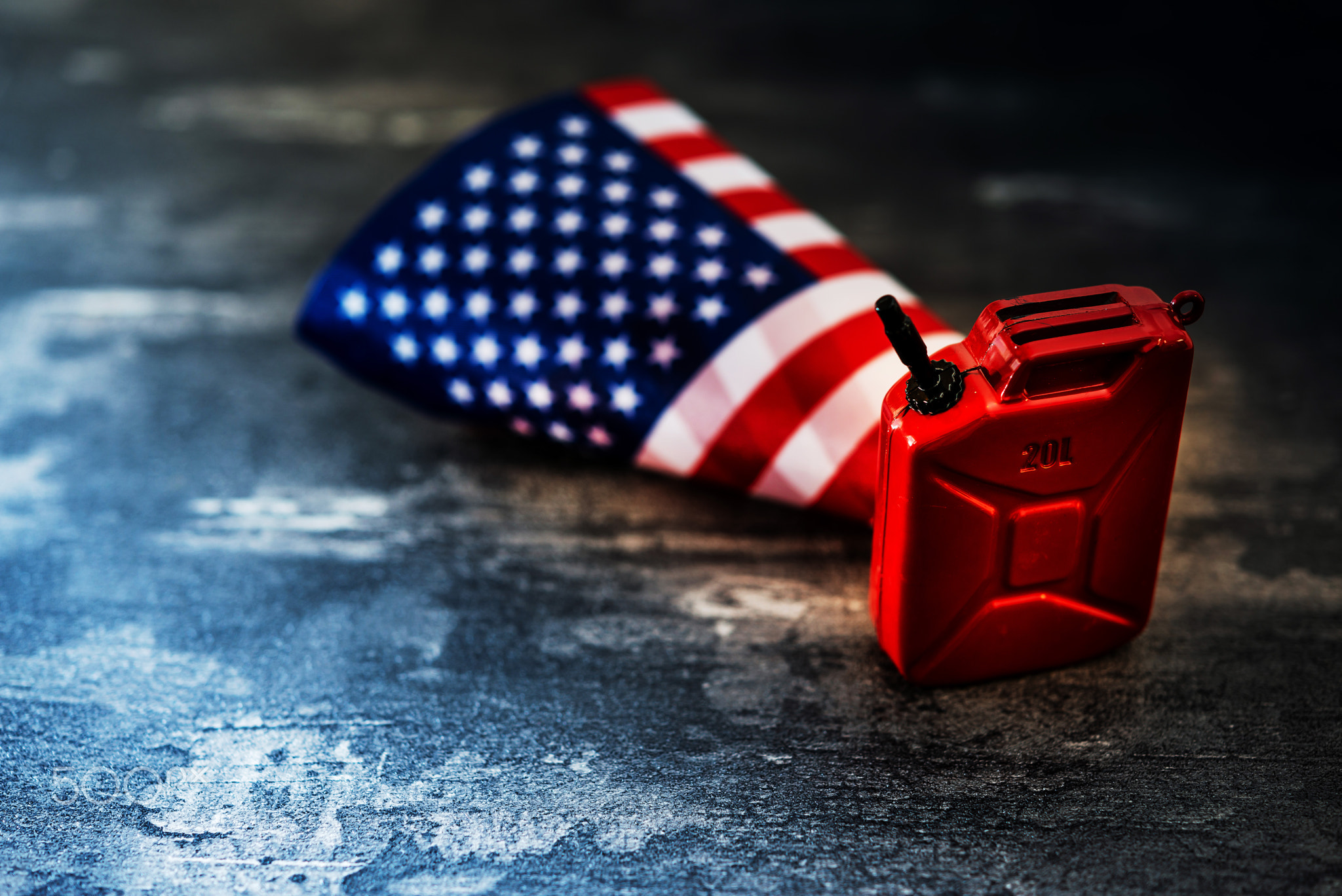 United States flag and oil Barrel on black field