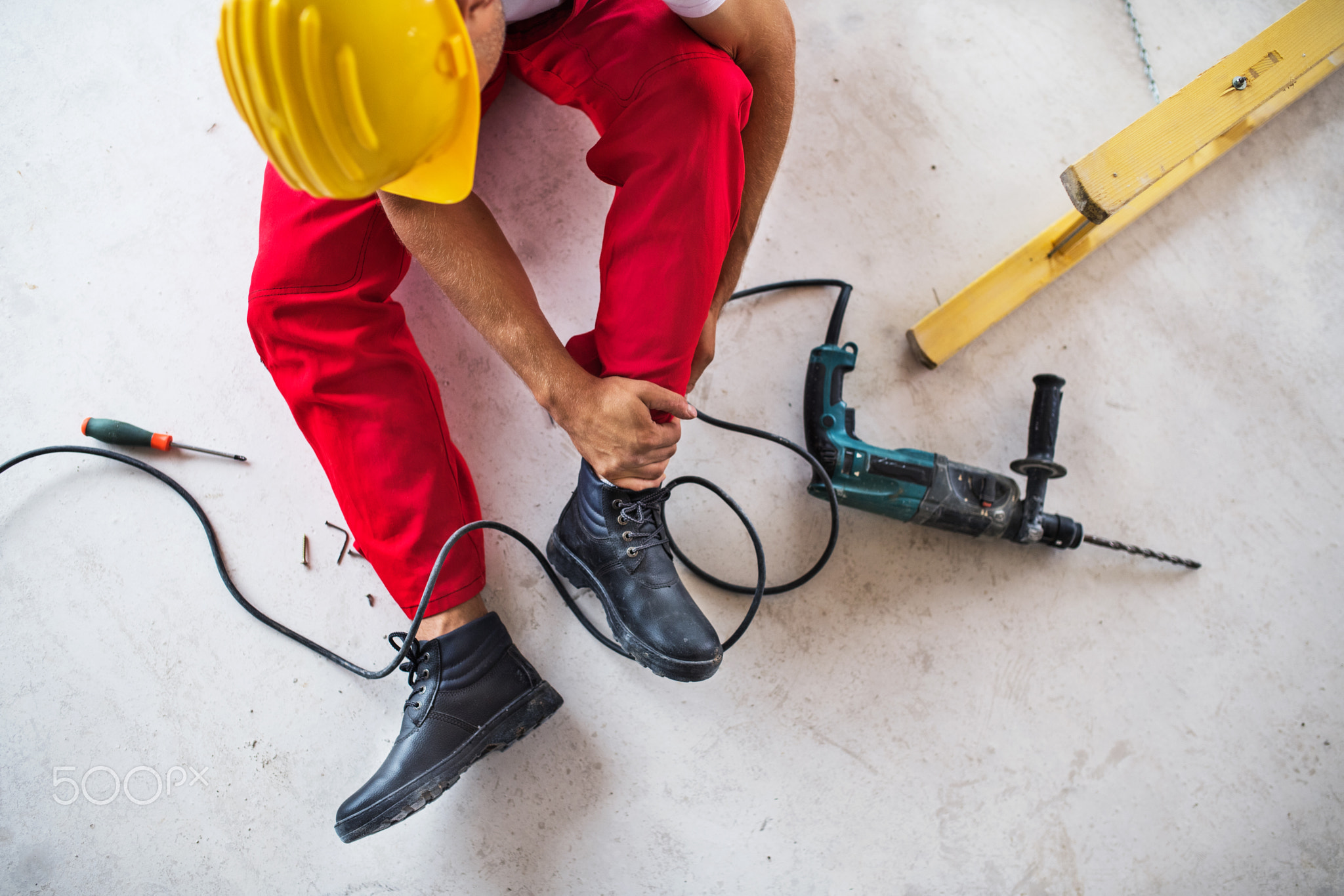 An accident of a man worker at the construction site. Top view.