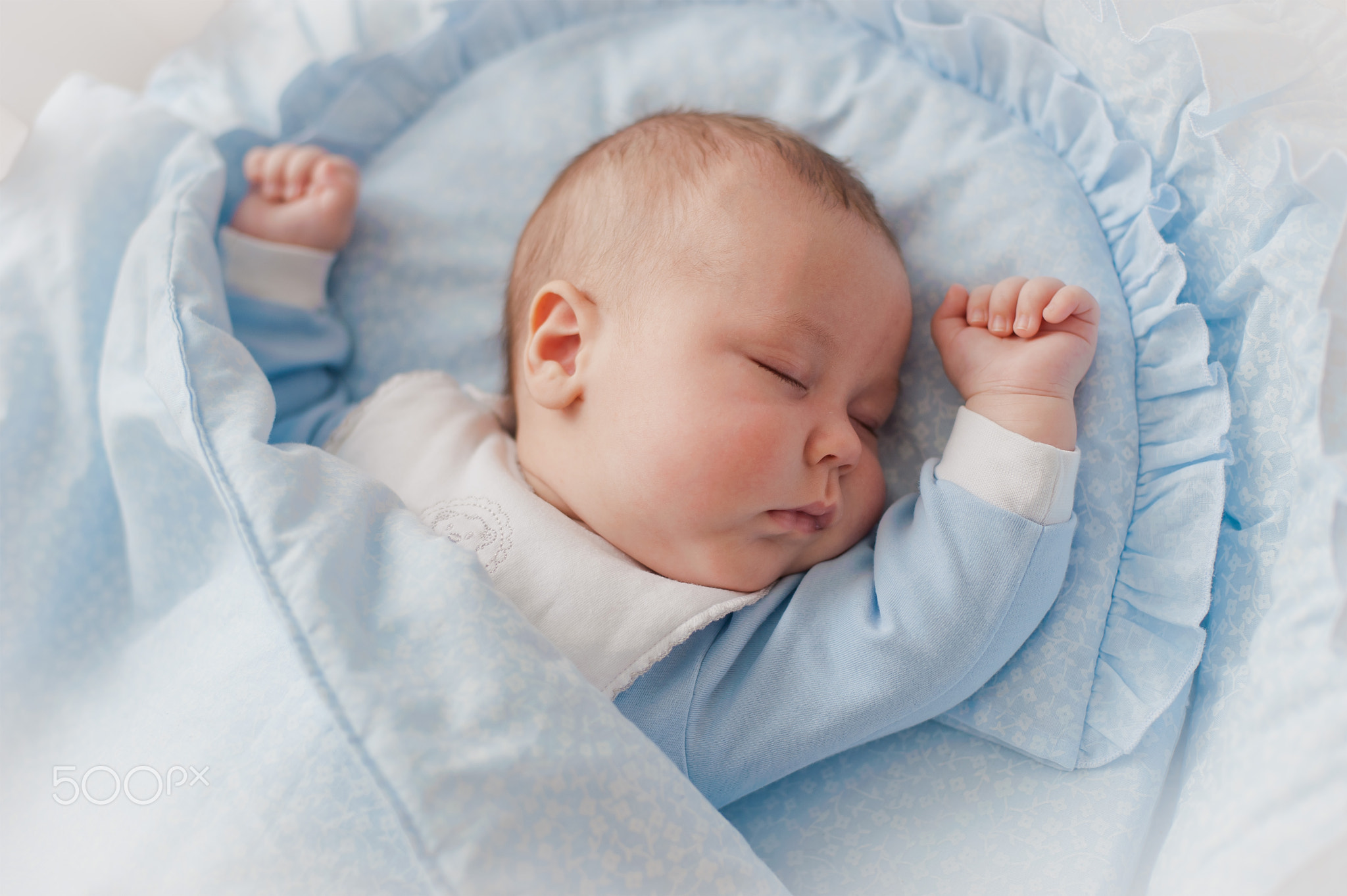 Baby's restful sleep. Newborn baby in a wooden crib. The baby sleeps in the bedside cradle.
