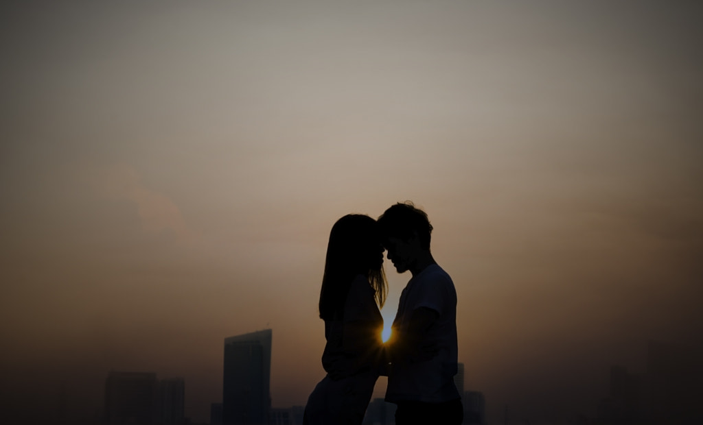 Silhouette of young loving couple hugging on the rooftop of city building close up. Romantic... by Anek Sakdee on 500px.com